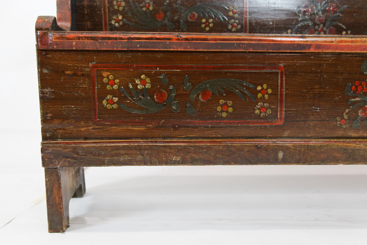 19th century long painted pine lift top bench, with double lift top seats, the back, seat and front painted with stylized flowers and foliate.