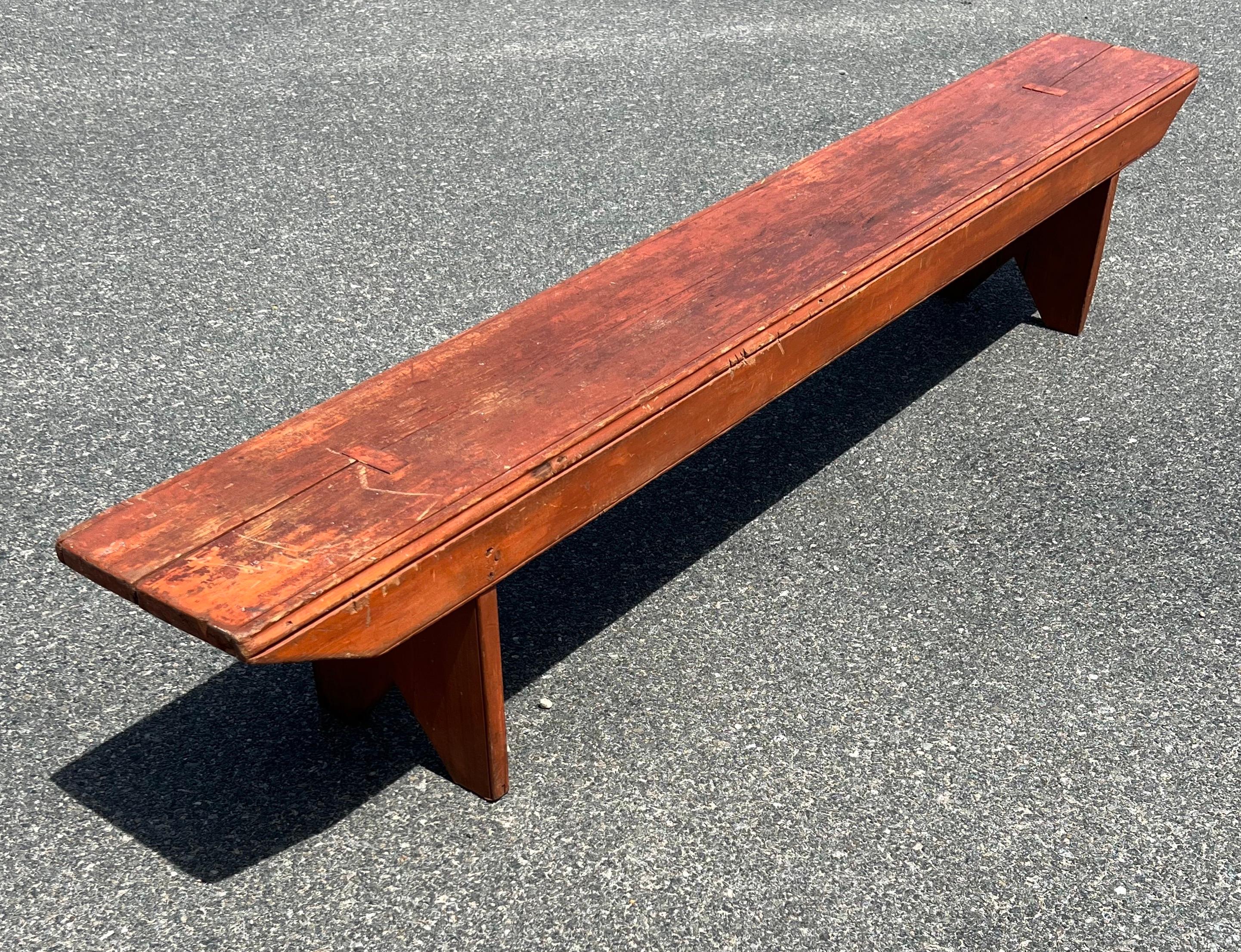 19th Century Pine Bench in rather long size.  With original orange paint and boot jack legs.  
