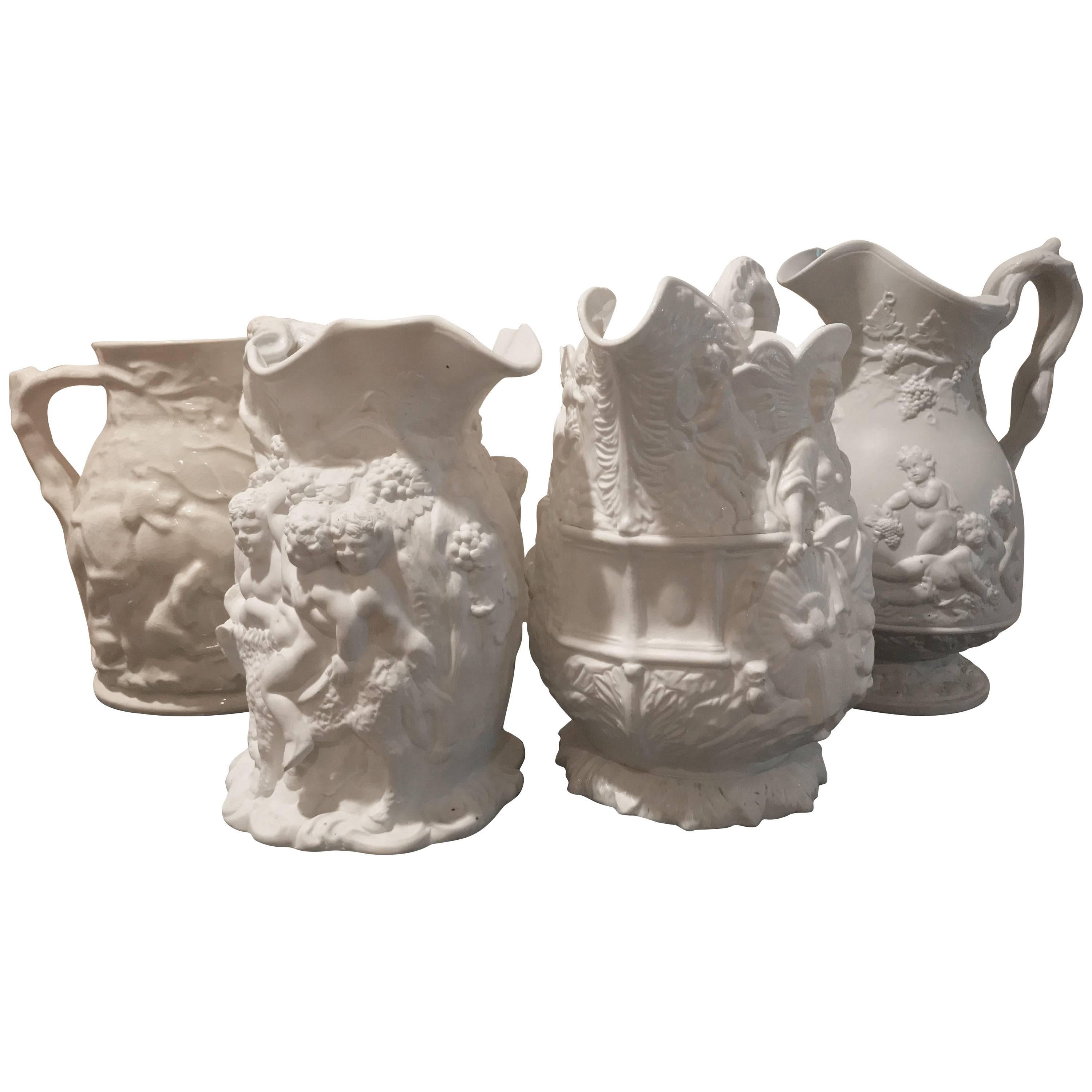 19th Century Lot of Four Porcelain Relief Pitchers For Sale