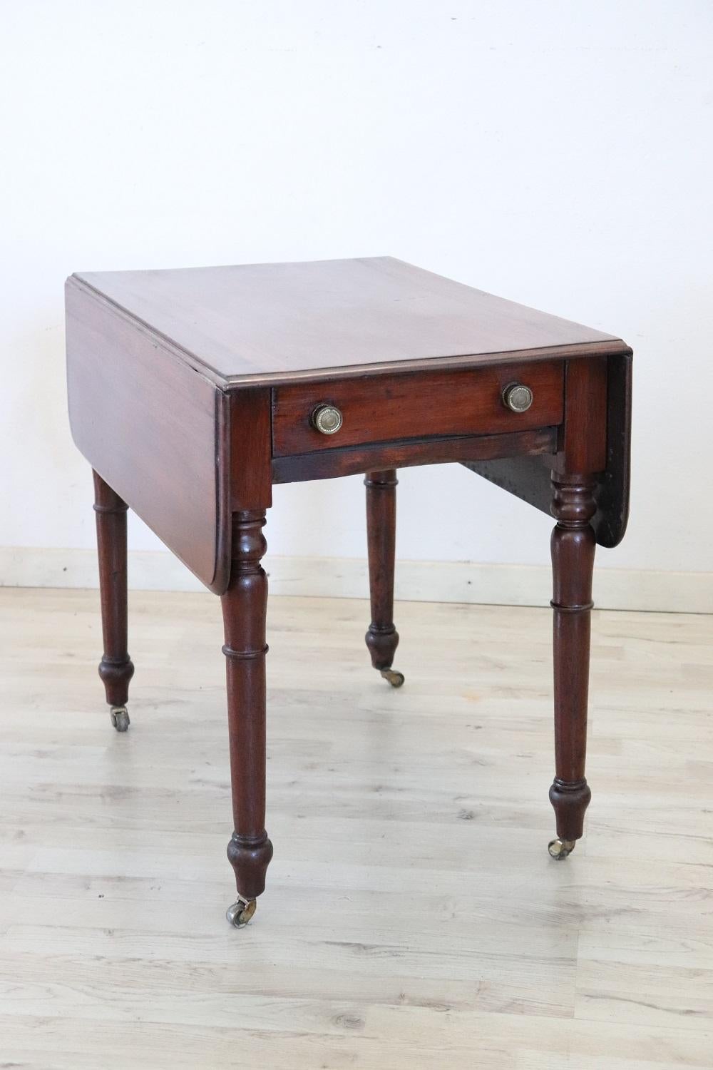 Lovely italian of the period Louis Philippe solid wood tilt top table. Featuring legs with refined turned decoration. Equipped with a practical drawer. This table is perfect for small spaces, you can keep it closed and open it only when you need to