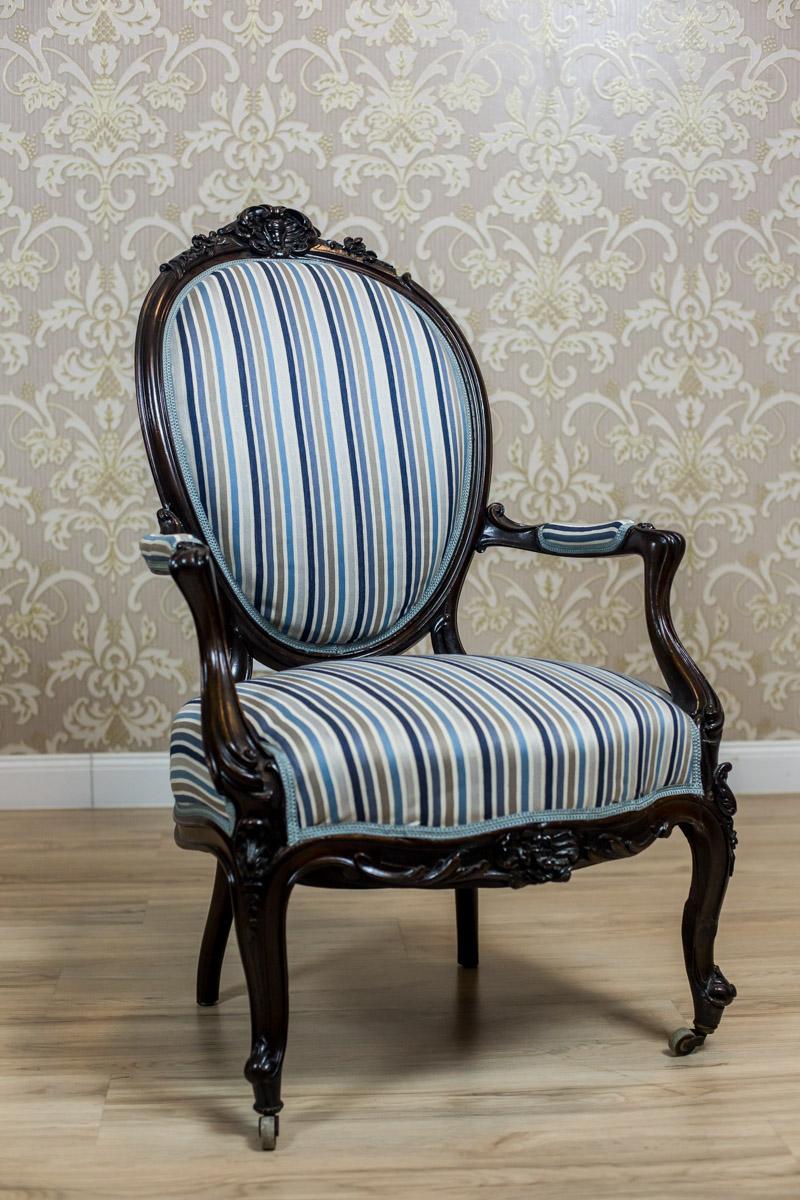 19th-Century Louis Philippe Style Mahogany Armchair

A piece of furniture from the first half of the 19th century, made of mahogany wood with softly upholstered seat and backrest. The armchair features cabriole front legs, a medallion-shaped