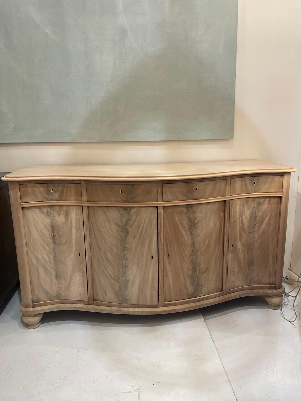 The Louis Philippe buffet, a hallmark of 19th-century French design, blends elegance with functionality. Its ample storage, featuring drawers and cabinets, accommodates tableware and linens. Whether in dining rooms, living areas, or hallways, this
