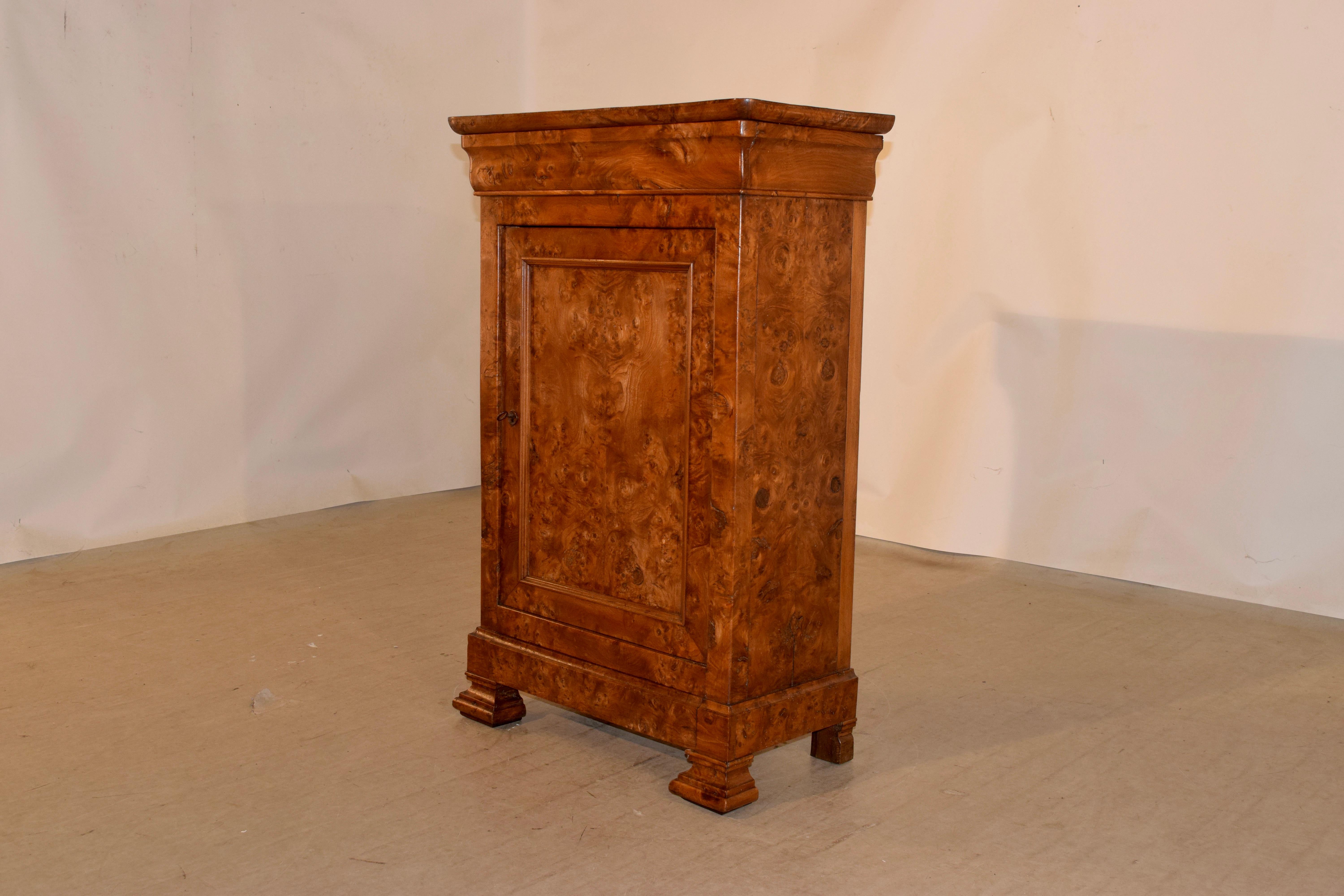 19th century Louis Philippe cabinet made from burl walnut. The entire cabinet has fantastic graining and is a most gorgeous color. There is a molded apron around the top, following down to simple sides and a single door, which opens to reveal