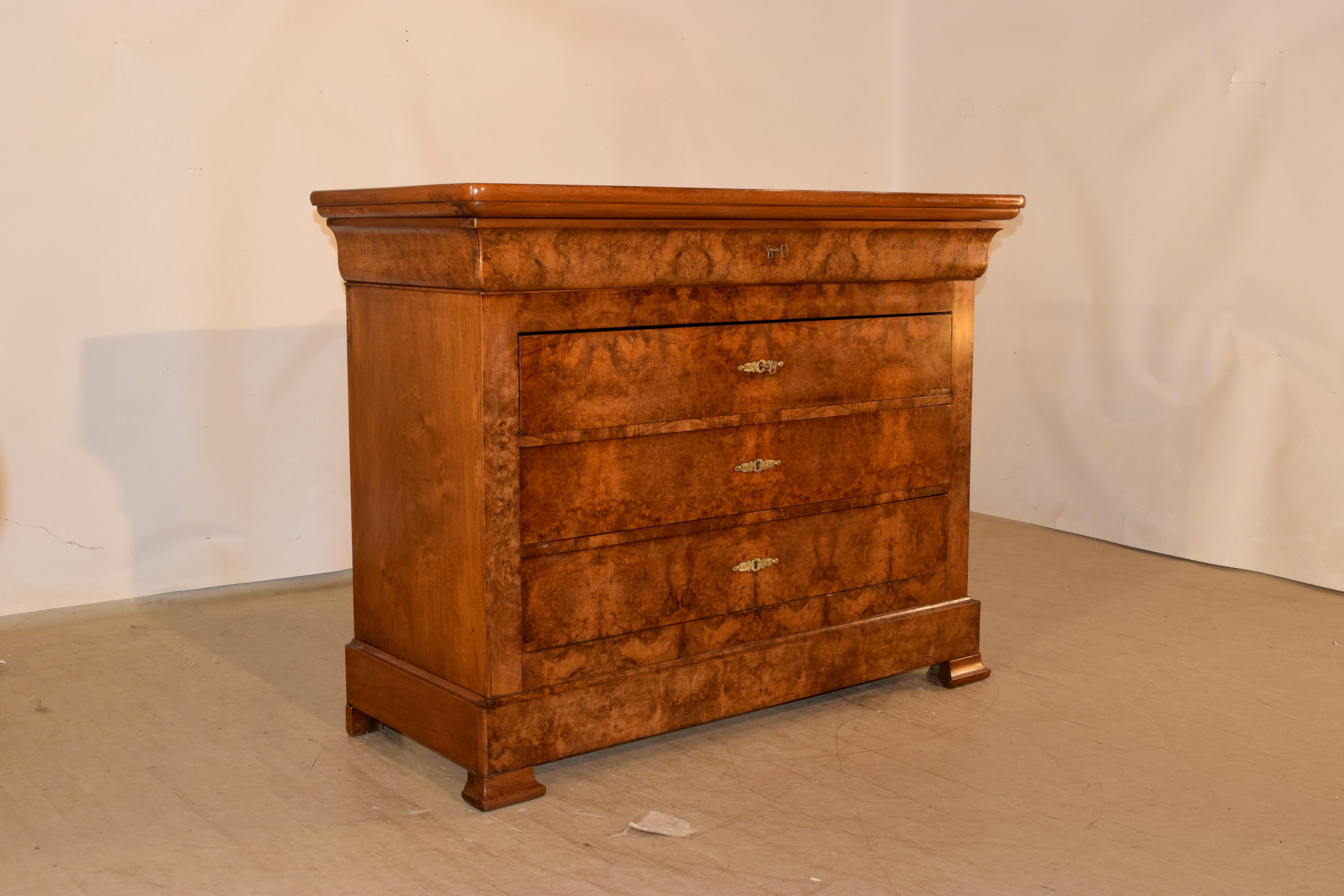 19th century Louis Philippe walnut commode from France with a beautifully grained and banded top, following down to simple sides and four drawers which are made from burl walnut for extraordinary design on the front. The top drawer is hidden in the