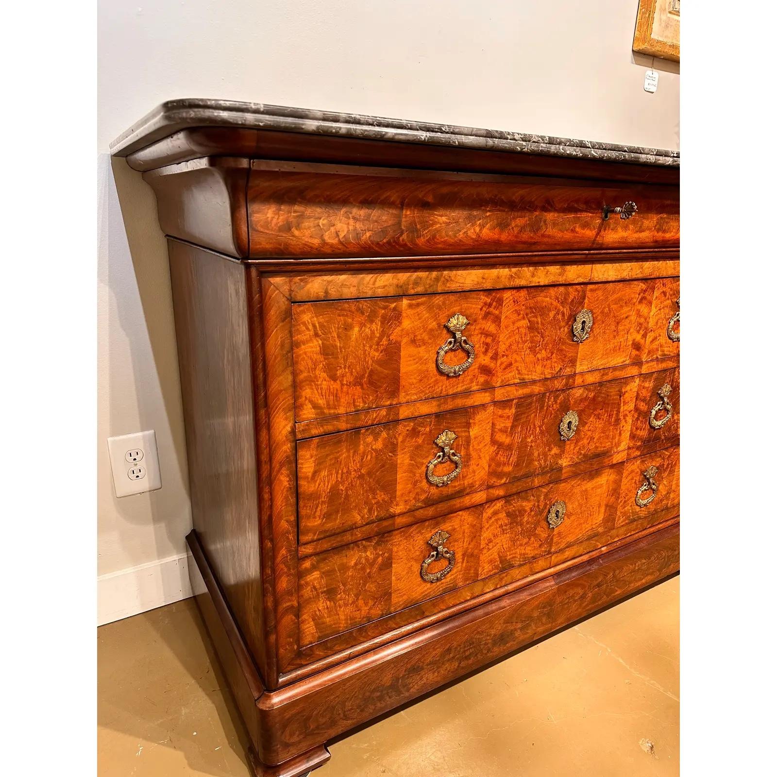 This magnificent French chest is the epitome of everything the Louis Philippe style stands for! The front is a show stopping portrayal of burled wood and skilled craftsmanship. Clean and even lines, with smooth sliding drawers. The ornate brass