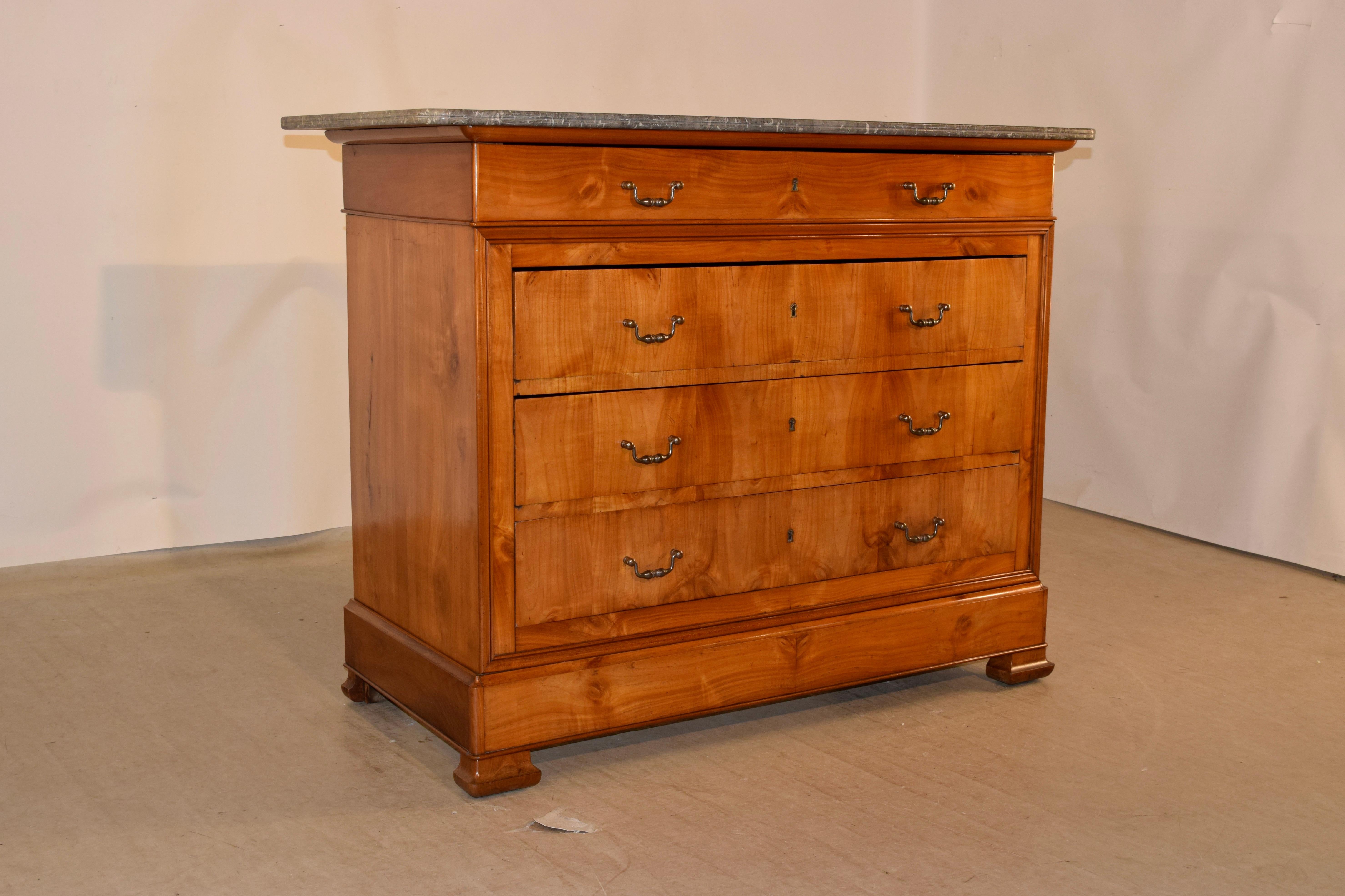 19th century Louis Philippe commode made from cherry with a wonderfully grained gray marble top following down to four drawers over a banded base and raised on shaped bracket feet. The sides are simple and also wonderfully grained with a banded top