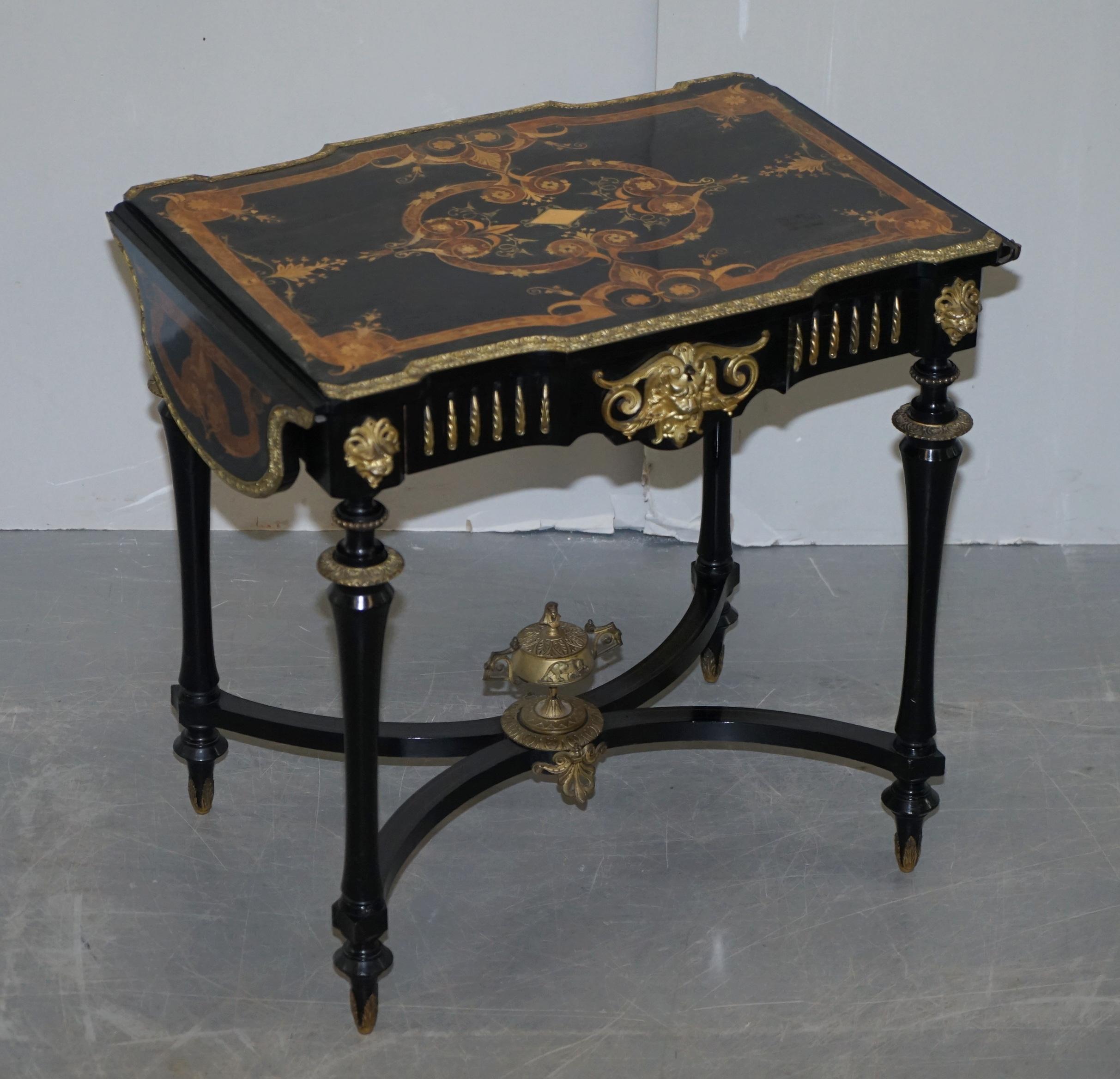 We are delighted to offer for sale this stunning original 19th century Louis Philippe Ebonised & Marquetry inlaid writing table with extending side leaves and gilt bronze fixtures and fittings 

A very fine table, made from luxury amboyna and