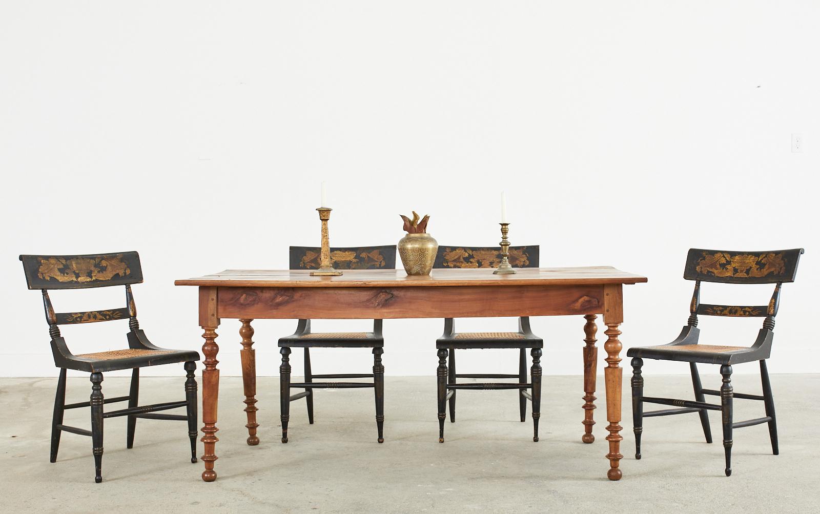 Handsome 19th century French Louis Philippe period farmhouse dining table or harvest table hand-crafted from fruitwood. The top features 1 inch thick planks of fruitwood. The case has wood peg joinery and a storage drawer on one side. The table is