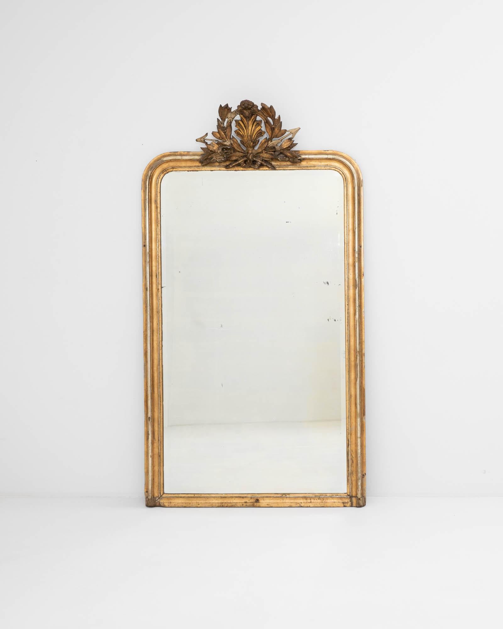Crafted in 19th-century France, this magnificent Louis Philippe mirror flaunts a gilded frame that artfully combines smoothly rounded top corners with squared-off bottom corners. This design imparts a sense of balanced geometry, making the mirror a