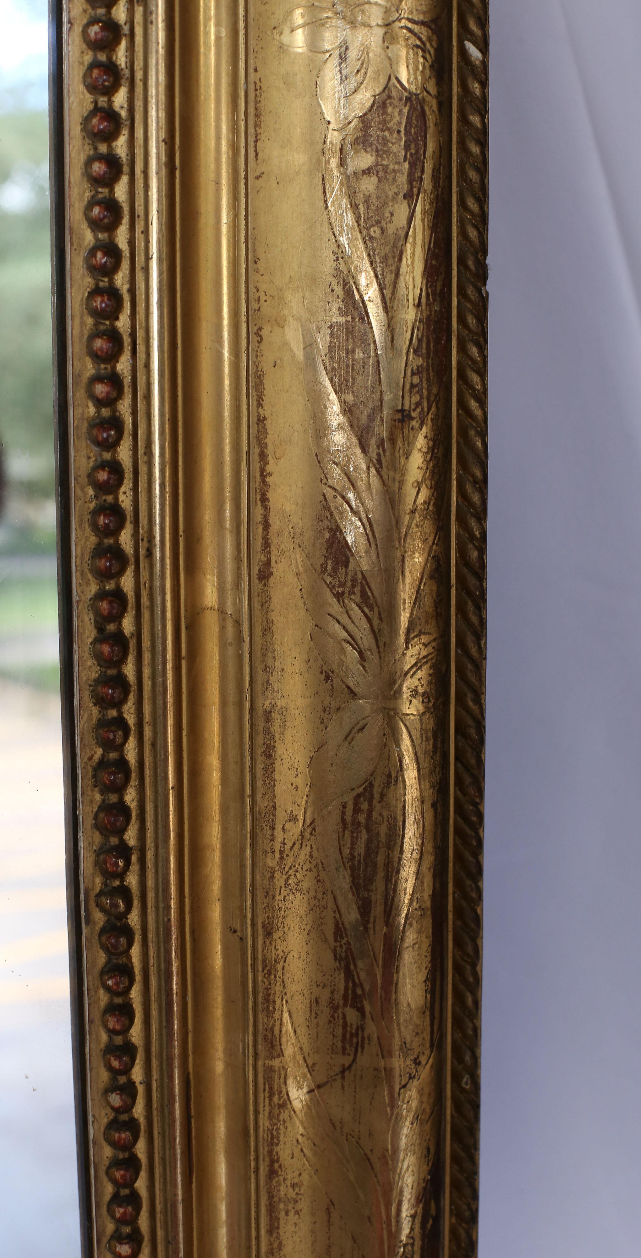 19th century Louis Philippe gilt mirror with beautiful floral etching and a rope perimeter on the exterior. The interior detail includes a pearl rope nearest to the glass.