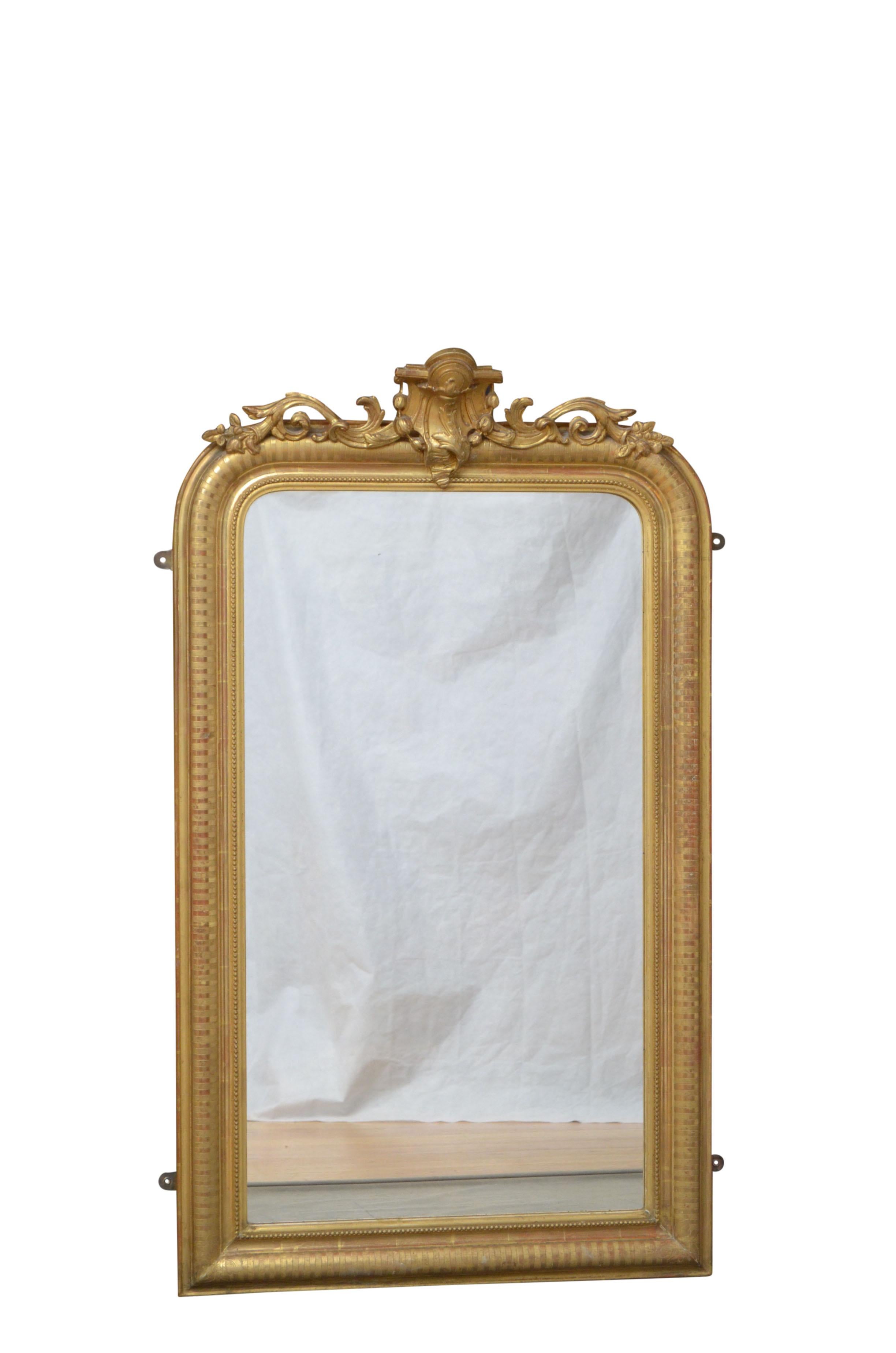 Very elegant Louis Philippe gilt wall mirror, having original glass with some foxing in beaded and carved gilded frame with floral crest to the centre. This antique mirror retains its original glass and gilt, repayment backboards, all in wonderful