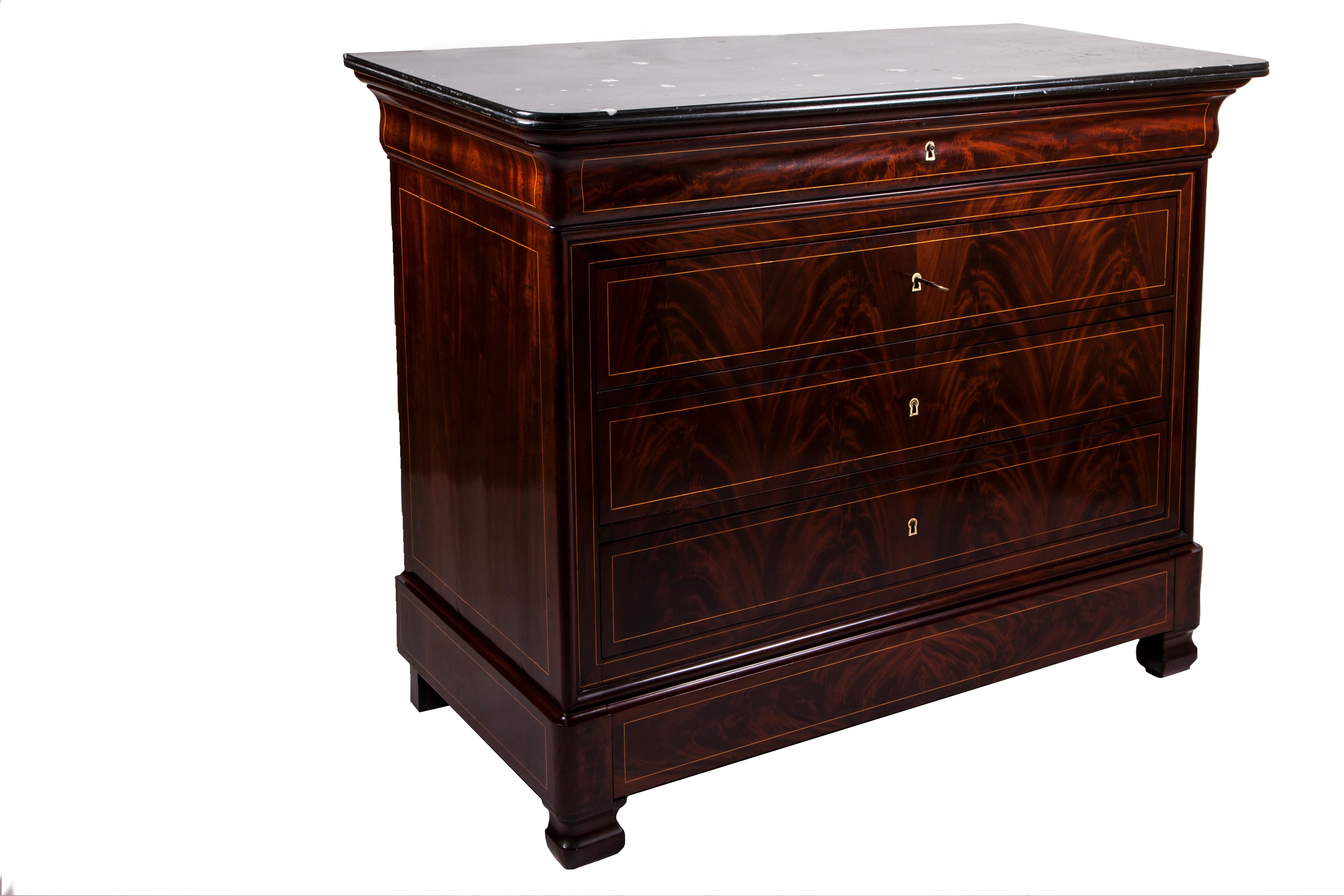 Elegant French Charles X style chest of drawers, in flamed mahogany and maple.
On the top, there is a beautiful veined black marble. 
The desk has the original leather and a series of small maple drawers.