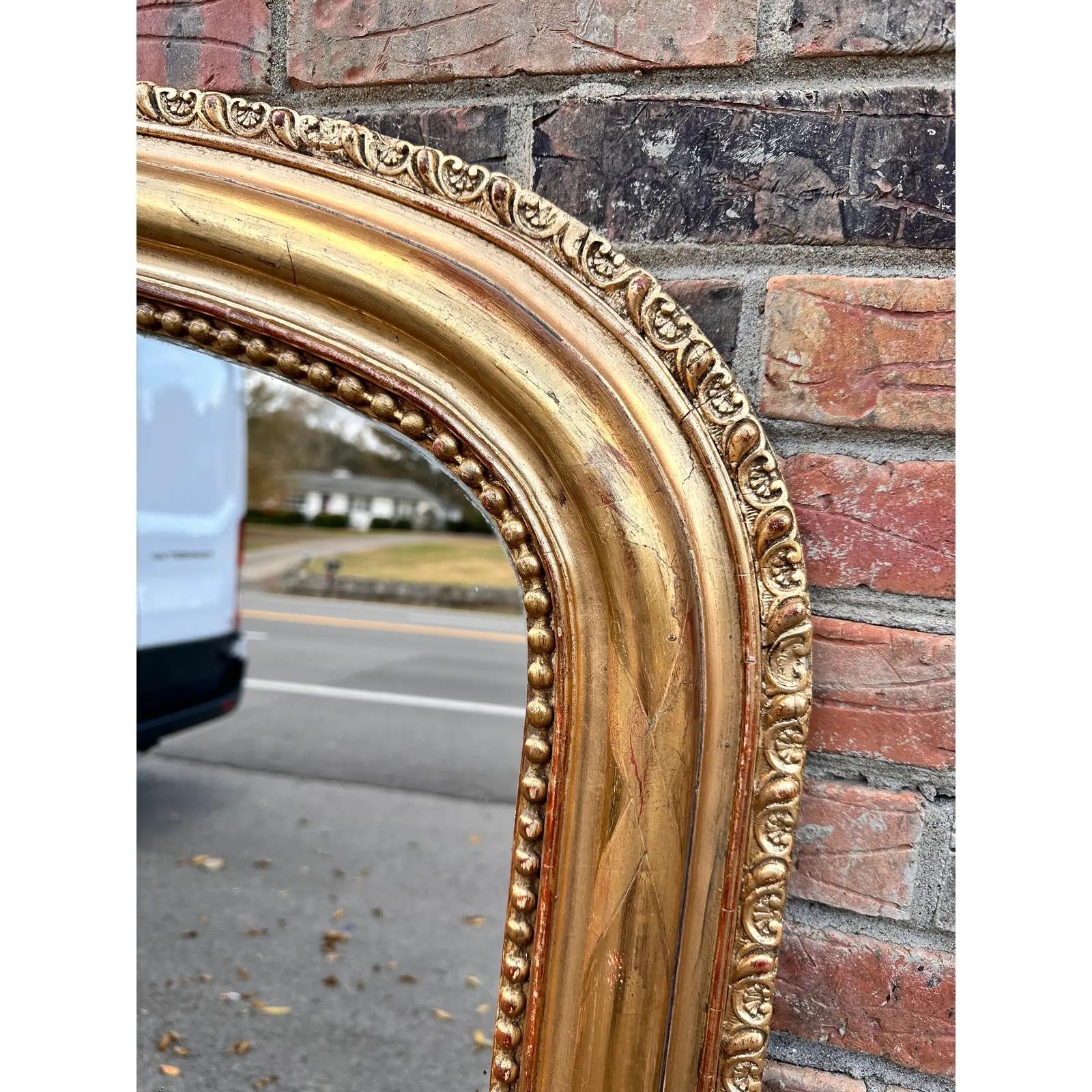 This is a gorgeous antique French mirror! This piece is in excellent condition, with all borders in tact- no missing pieces. The inner border is beaded, while the outer border is a beautiful hand carved floral and paisley pattern, with a light