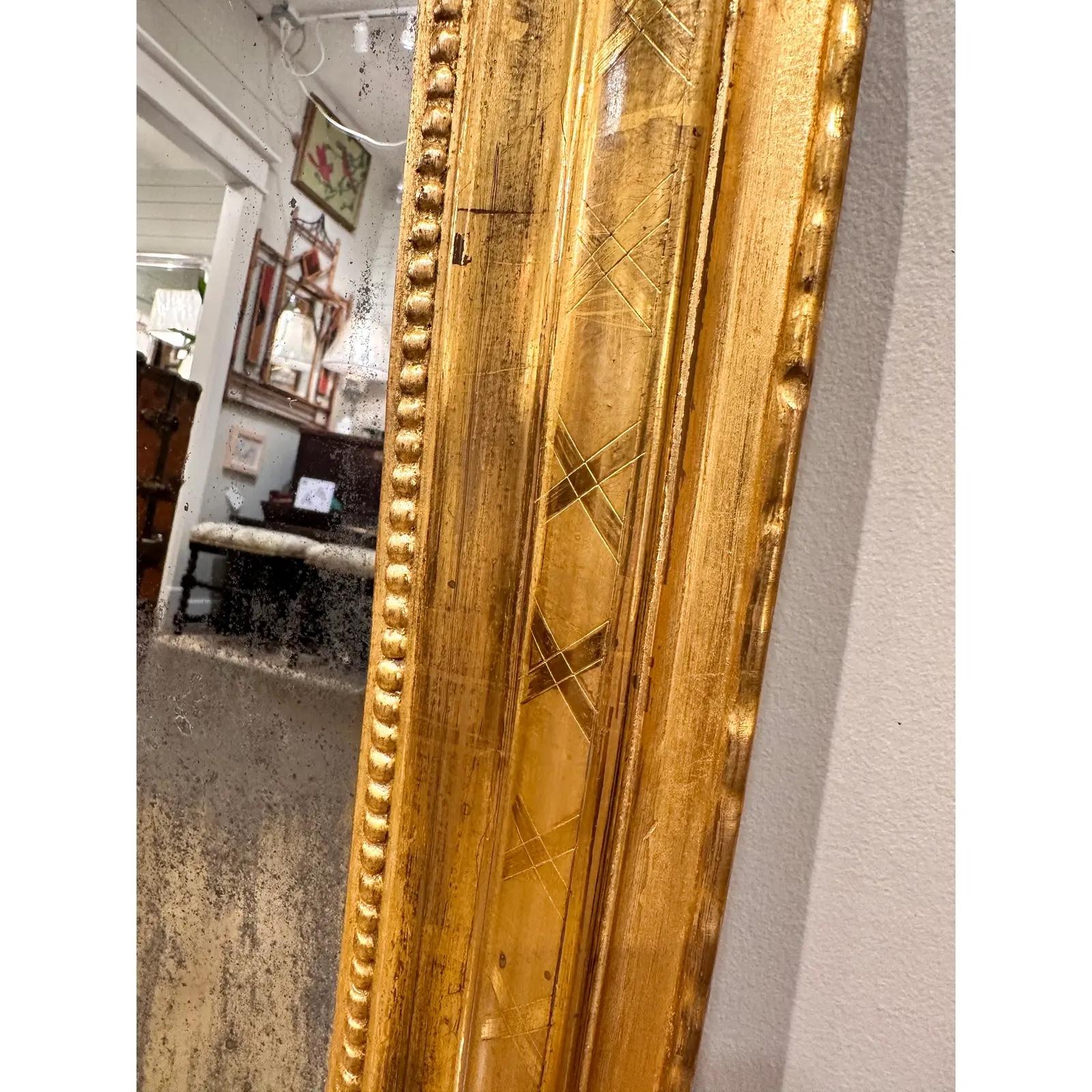 This is a stunning 19th Century Louis Philippe Mirror! The mirror has a pie crust edge, hand carved designing, and a fully intact beaded inner border. This mirror has aged excellently and has beautiful patina and foxing on the glass. This would be