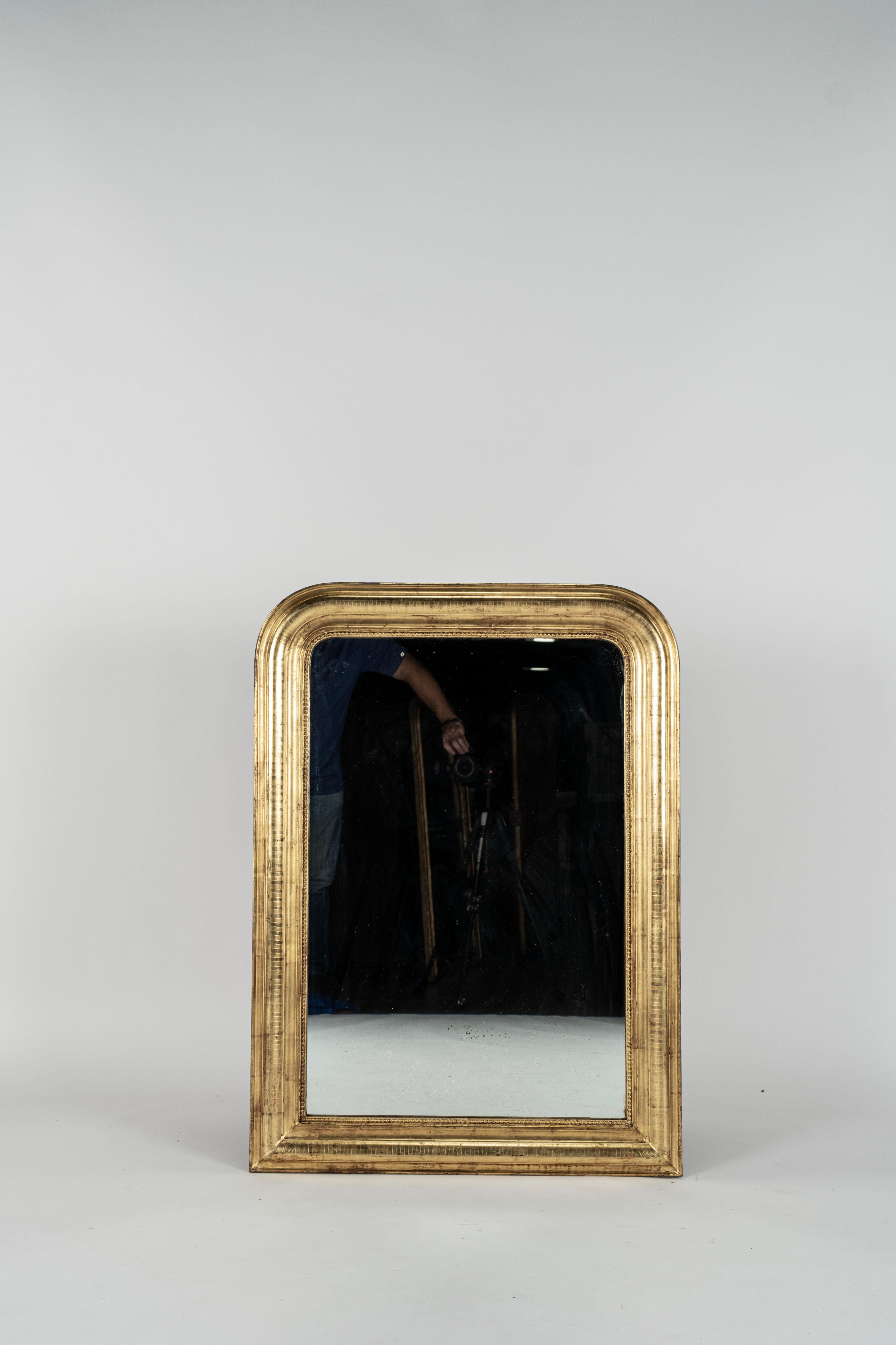  Antique French Mirror - Gilt on red Louis Philippe antique mirror with line etching to frame. Antique glass with some small black patination spots. Antique pine board back. Circa 1880. 