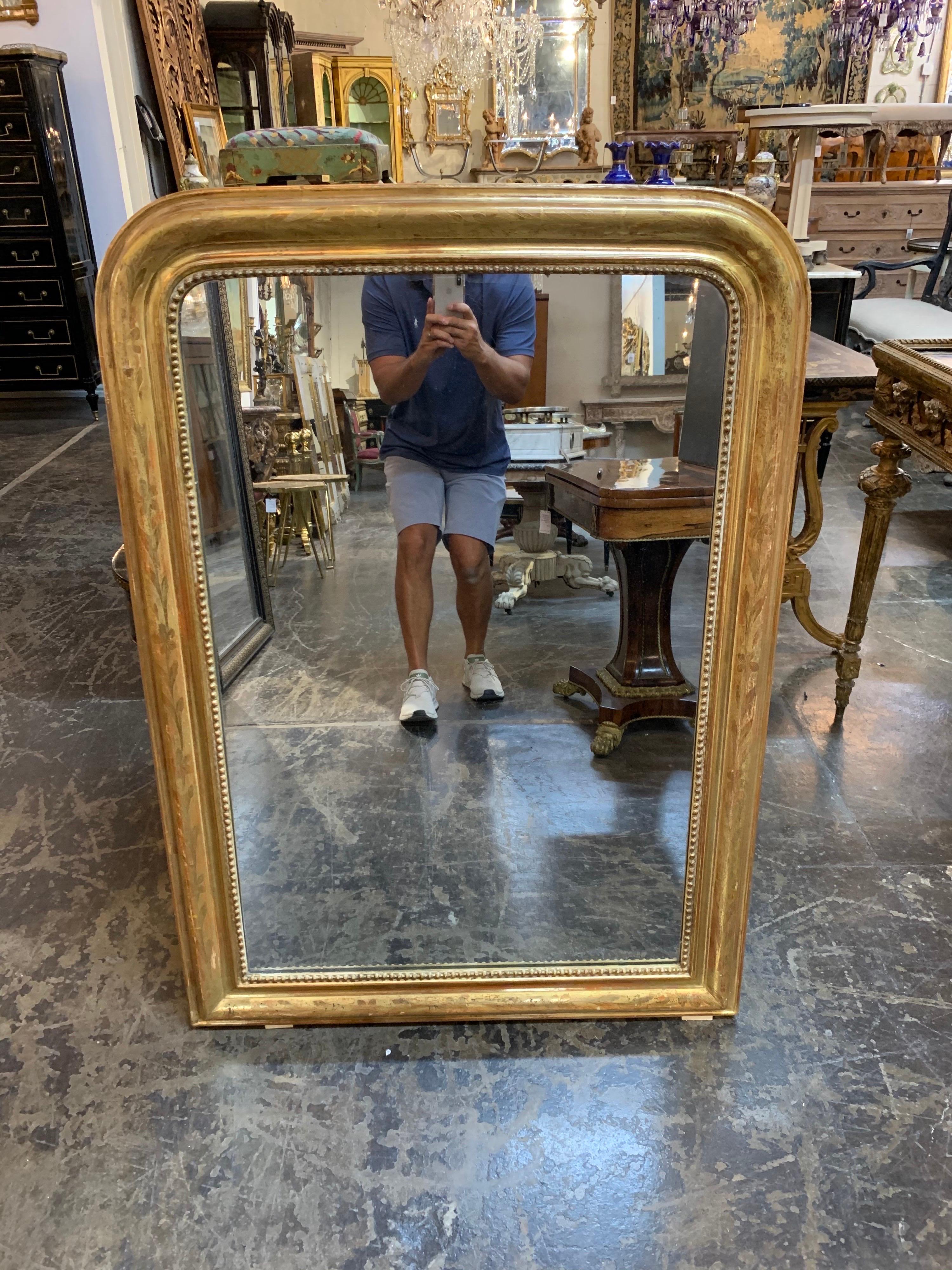 Lovely Louis Philippe mirror with beautiful gold gilt. The mirror has beaded detail on the inner border and a floral pattern. So pretty!
