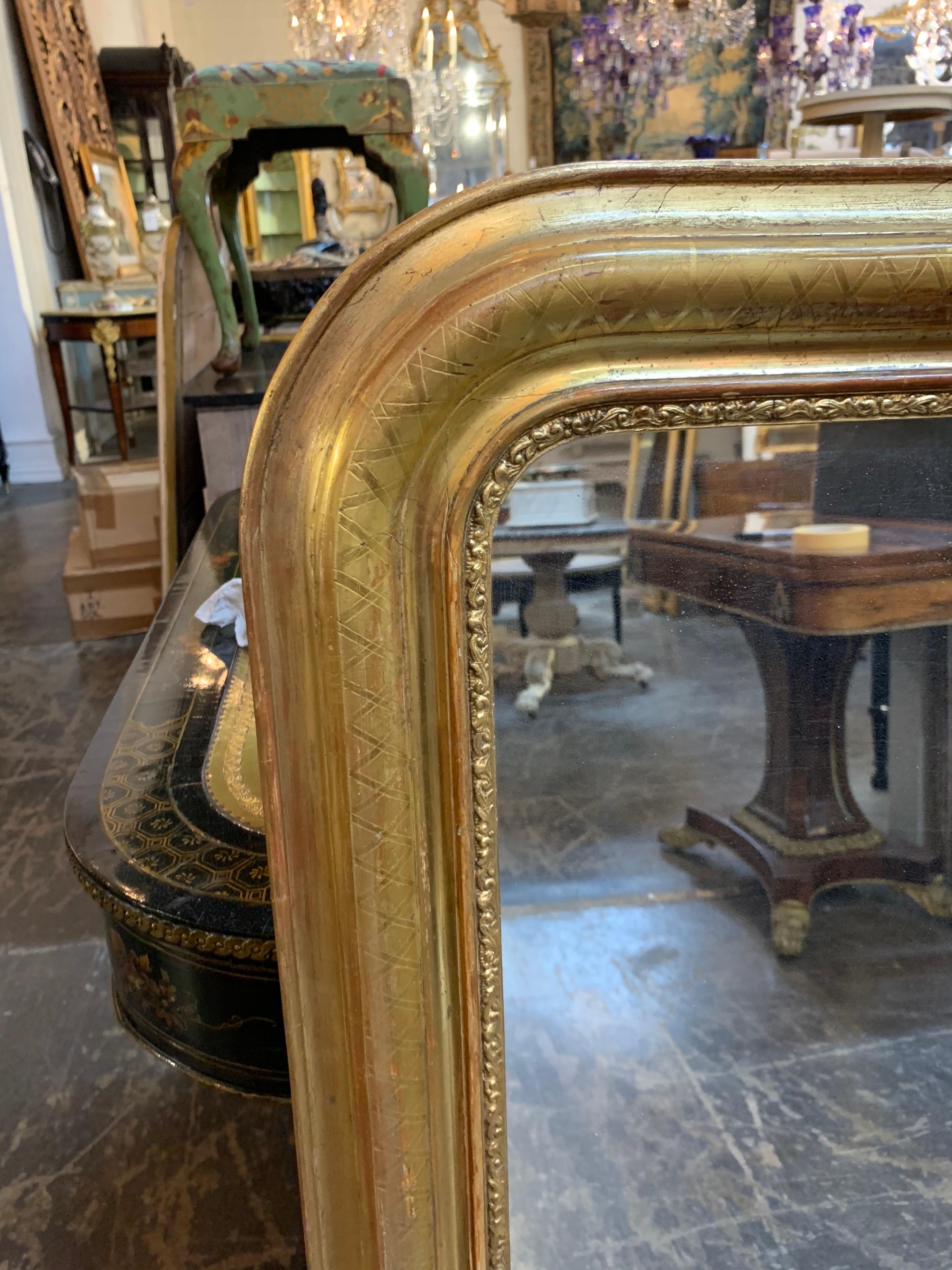 Gorgeous 19th century Louis Philippe mirror with X-pattern. This piece also has a decorative inner border and red undertones. Creatives a beautiful image!