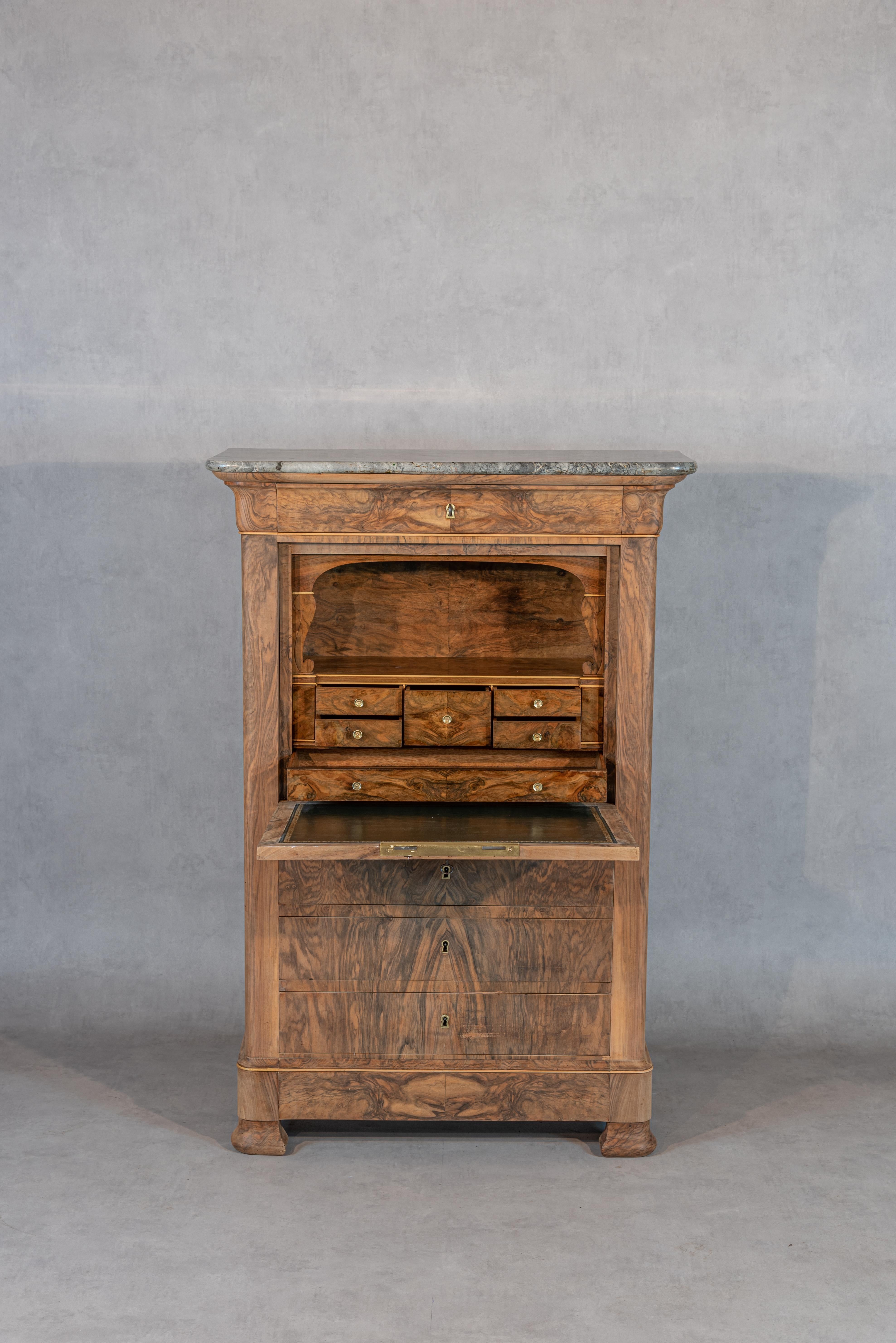 
Step into a world of refined elegance with this Antique Louis-Philippe Period French Secretary, meticulously restored to its former glory. The restoration has brought out the authentic craftsmanship of the Louis-Philippe era, showcasing the piece's