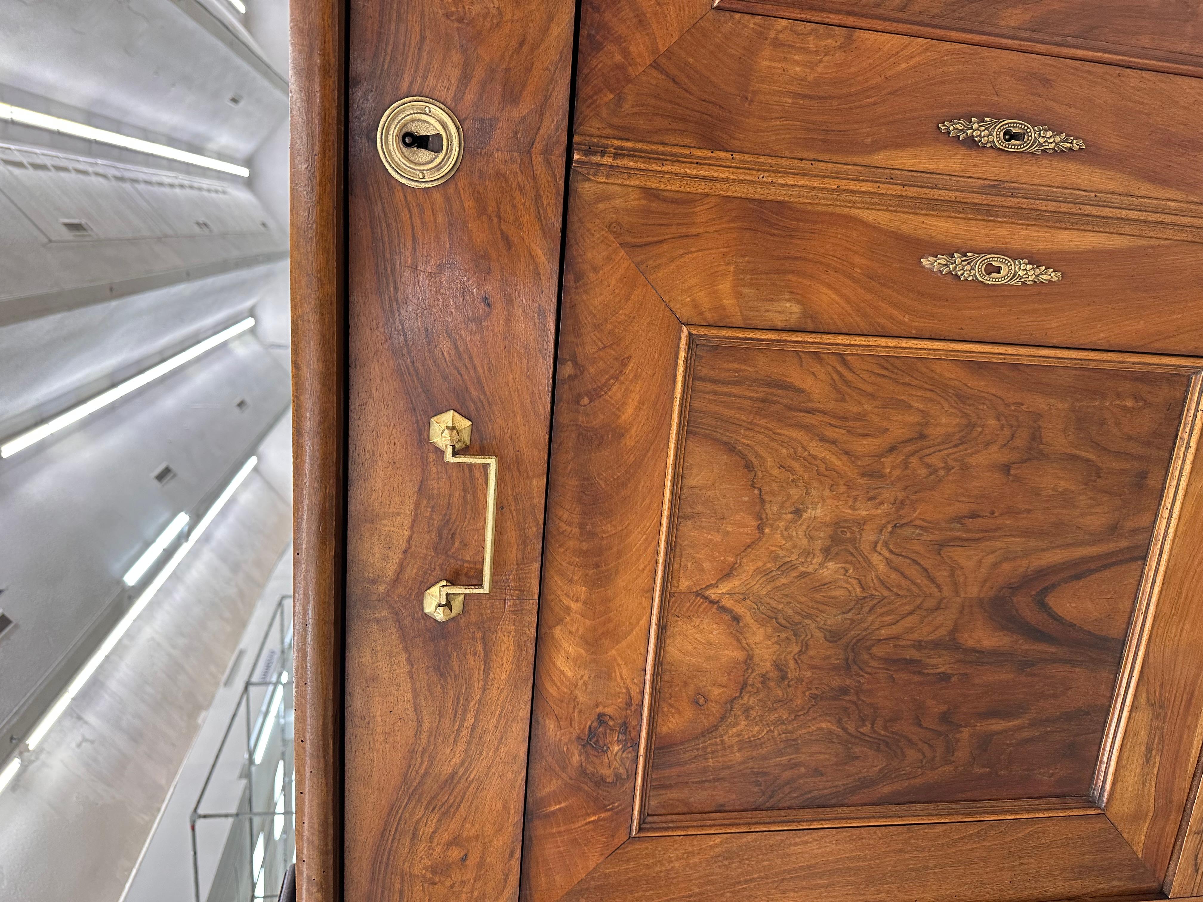 This is a beautiful 19th century French server! The burled walnut presents an amazing natural design that is excellently showcased by the clean and simple lines of the Louis Philippe era. The brass escutcheon and handles adds just the right amount