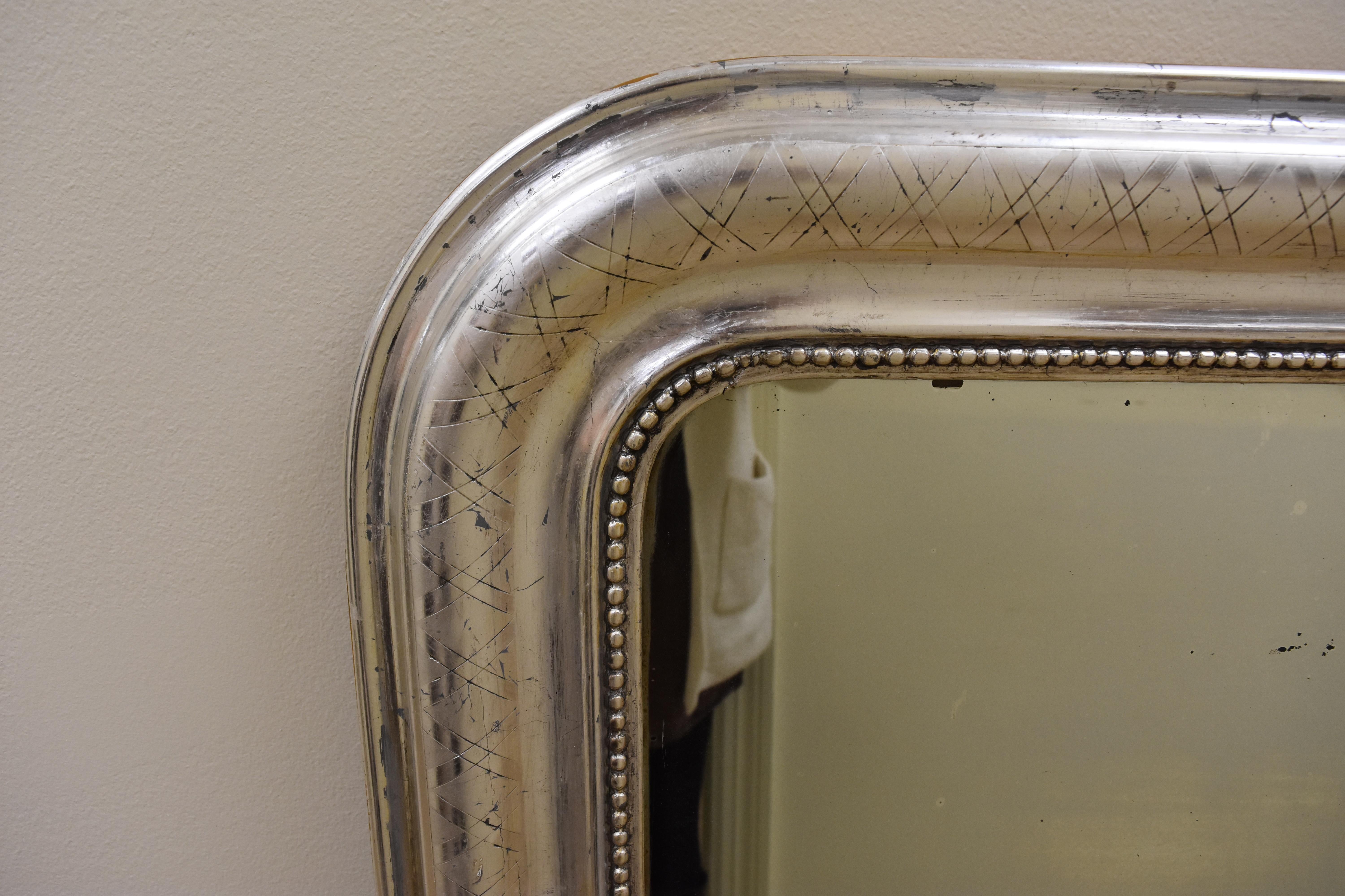 This French 19th century Louis Philippe mirror features a stunning silver leaf finish and 