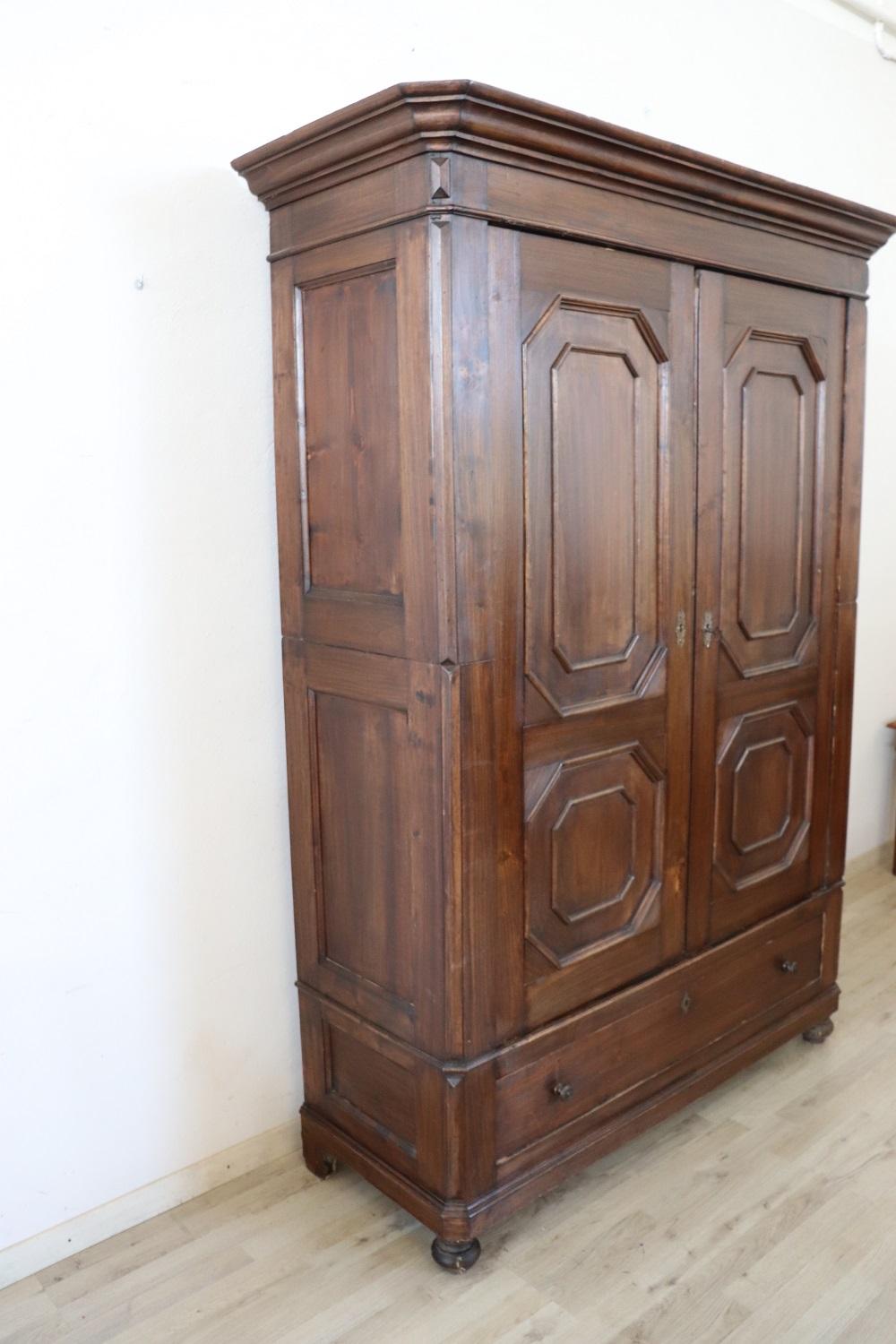 Antique wardrobe in solid poplar wood made in mid 19th century Italian of the period Louis Philippe. Very simple and linear enriched by geometric decorations on the doors . The interior is divided to have both shelves and a clothes rail. In the