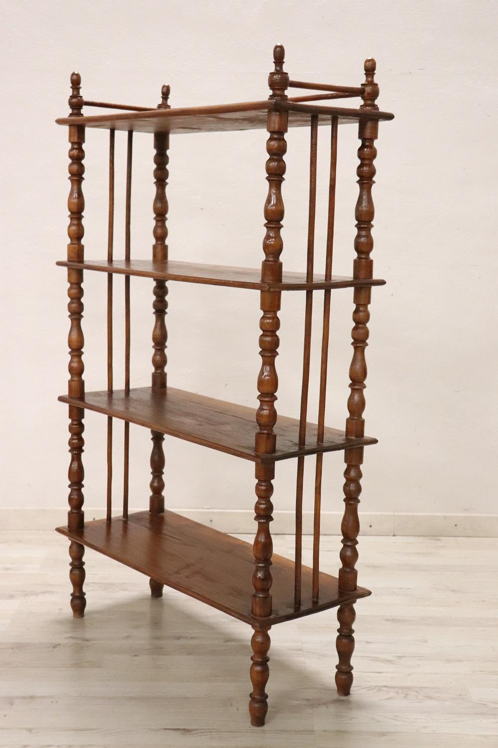 19th century of the period Louis Philippe italian antique étagère. Made in usual solid chestnut wood and characterized by refined turned columns. Equipped with four shelves available to display your objects or books. The distance between the shelves