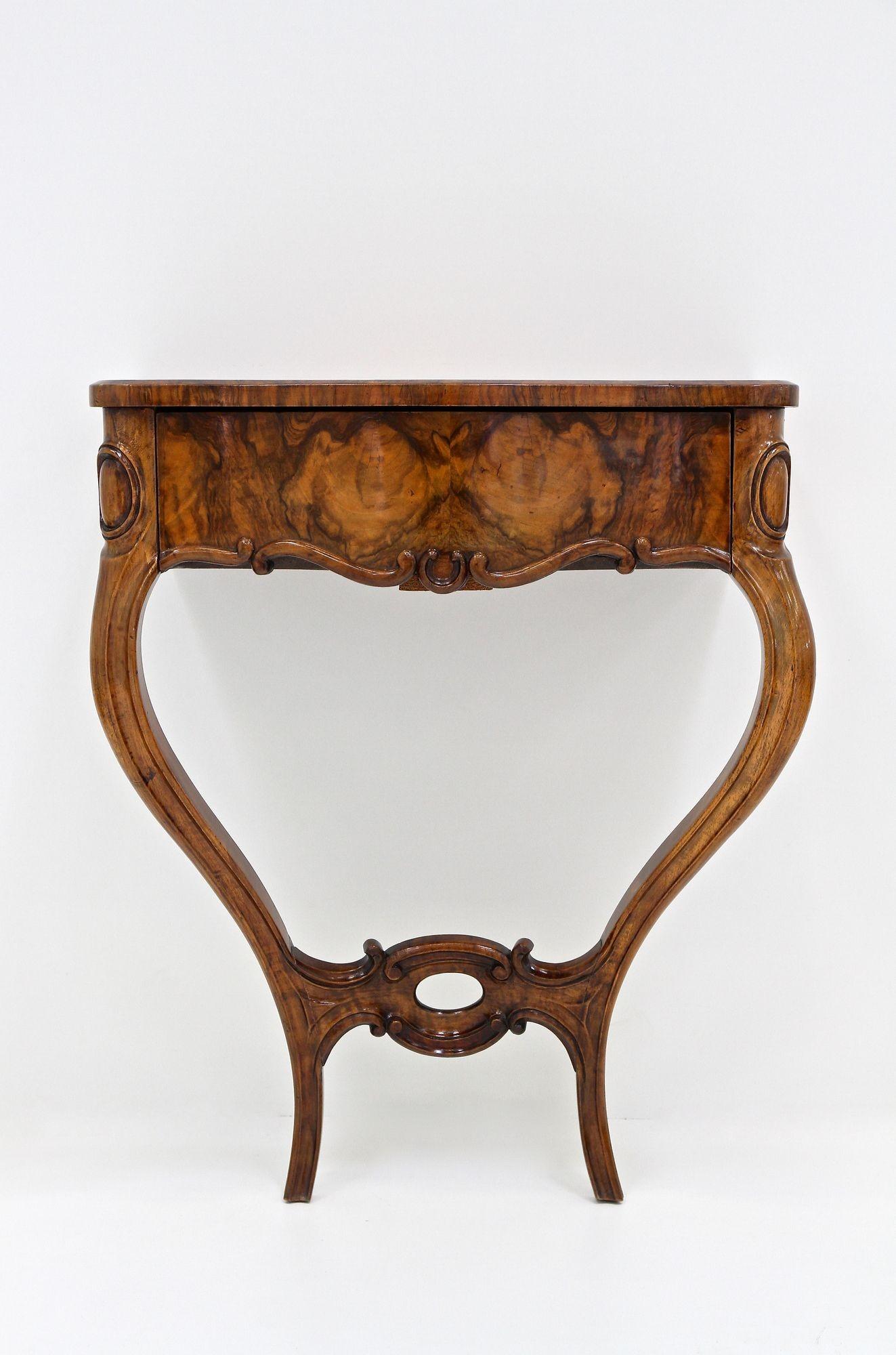 Elegant mid 19th century Louis Philippe wall console table, elaborately handmade in Austria during the period around 1860. This console table owes its look of opulence to the graceful curve of its legs and its rounded lines, indicative of the era in