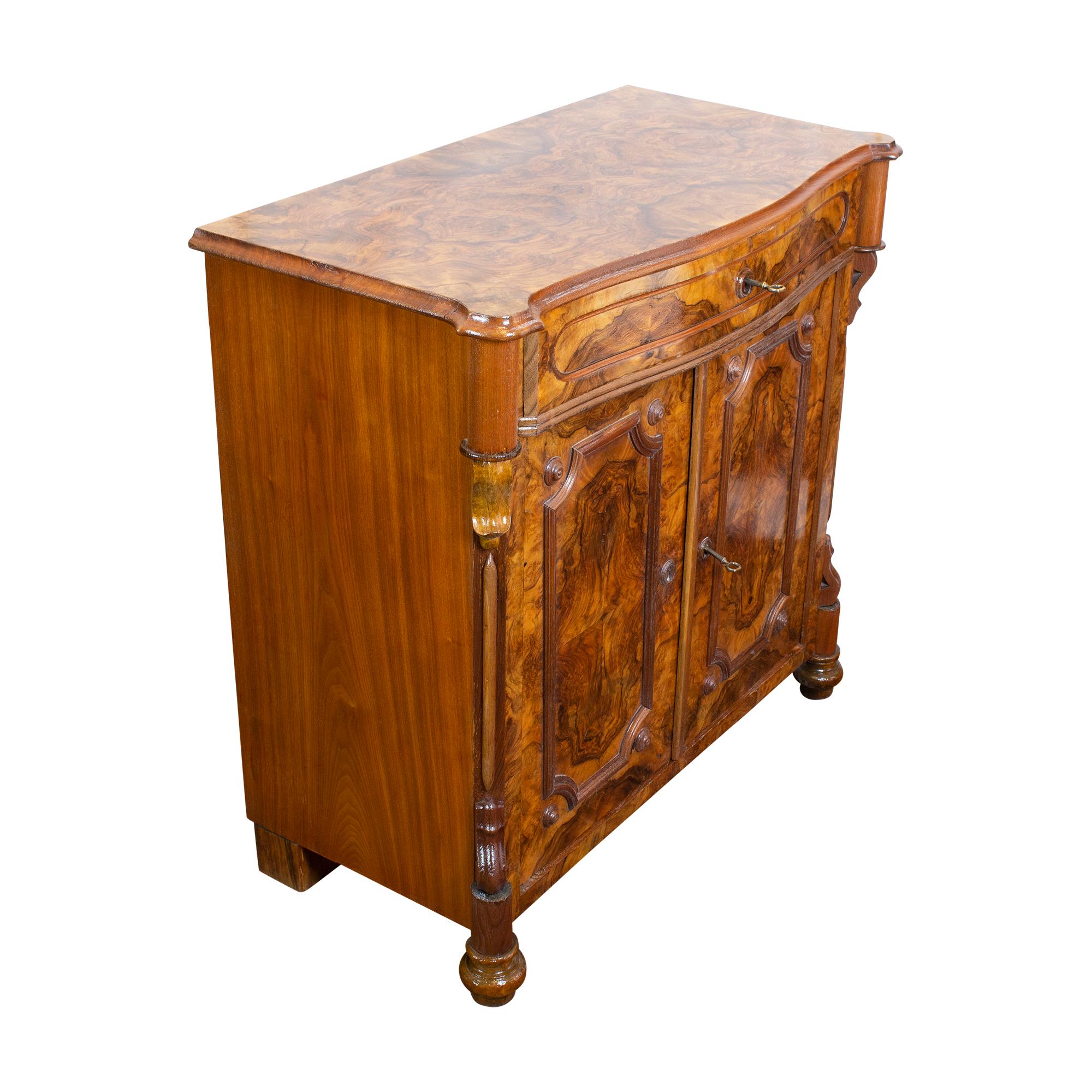 Discover the timeless charm of this exquisite Louis Philippe/Late Biedermeier half cabinet, crafted around 1850. This remarkable piece features a single drawer and two doors, offering ample storage space. Its rich walnut veneer adorns a sturdy