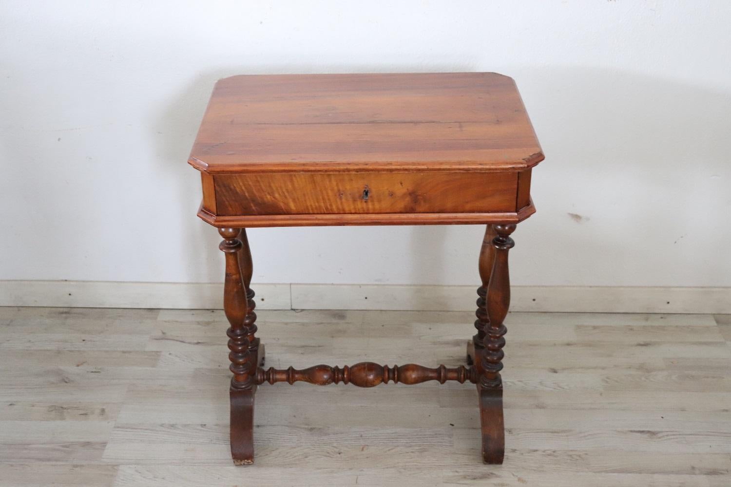 Lovely italian of the period Louis Philippe walnut side table. Featuring legs with refined turned decoration. On the front a drawer internally divided into small compartments. A small table that can be used in different rooms of the house: in the