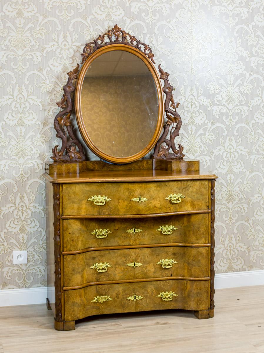 19th Century Louis Philippe Walnut Vanity Table

We present you this piece of furniture, circa the 2nd half of the 19th century, with decorative veneer and striking carvings.
The vanity is composed of a four-drawer dresser and an upper section with