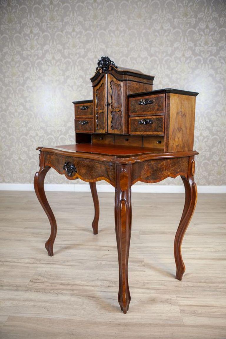 19th-Century Louis Philippe Walnut Wood & Veneer Secretary Desk After Renovation

Delicately shaped and richly adorned, this 19th-century secretary desk in the style of Louis Philippe features numerous small drawers and a pull-out writing