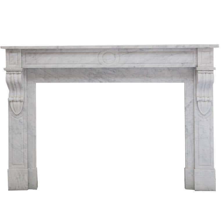 Unique opportunity to acquire a rare 19th century antique, French Louis Phillipe fireplace mantel. Hand carved in desirable Italian Carrara marble. Recessed paneled jambs and frieze with carved centre circle and elegantly carved corbels. Full