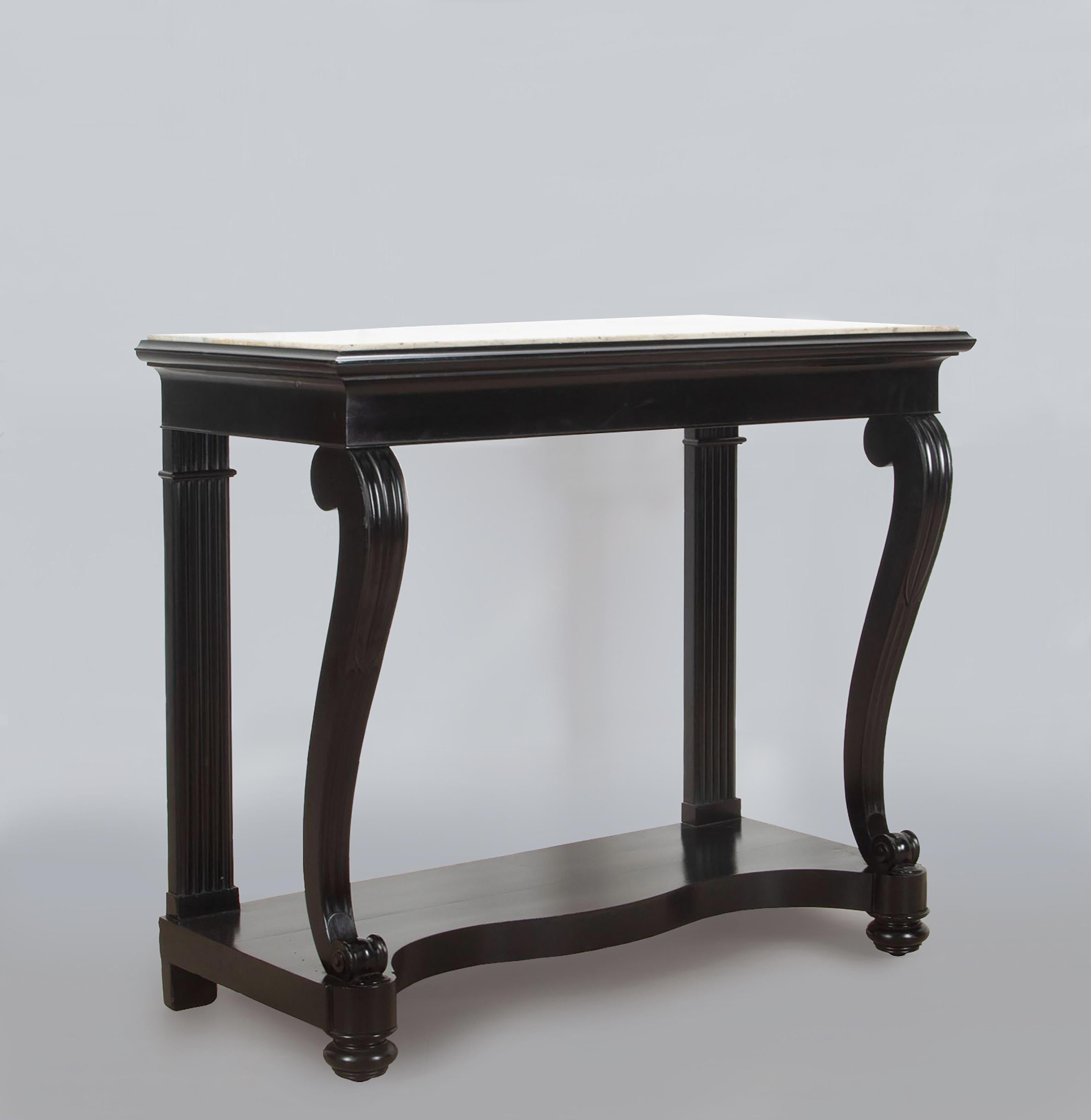 A very smart French 19th Century Louis Phillipe ebonised console table. 

With its original Carrera marble top sitting on shapely fluted legs above a serpentine platform. 

A very elegant and stylish console table.

Various minor chips and losses