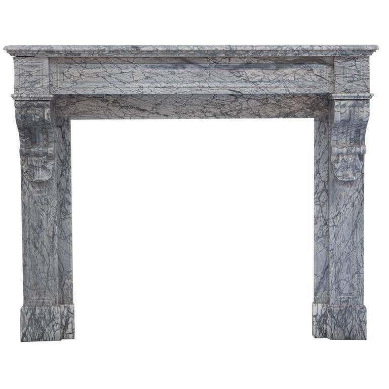 19th century antique French, Louis Phillipe fireplace mantel. Hand carved in desirable Italian bardiglio marble which is from the Carrara region in Italy. It’s a grey-blue crystalline marble with deep veins. Hand carved recessed panelled jambs and