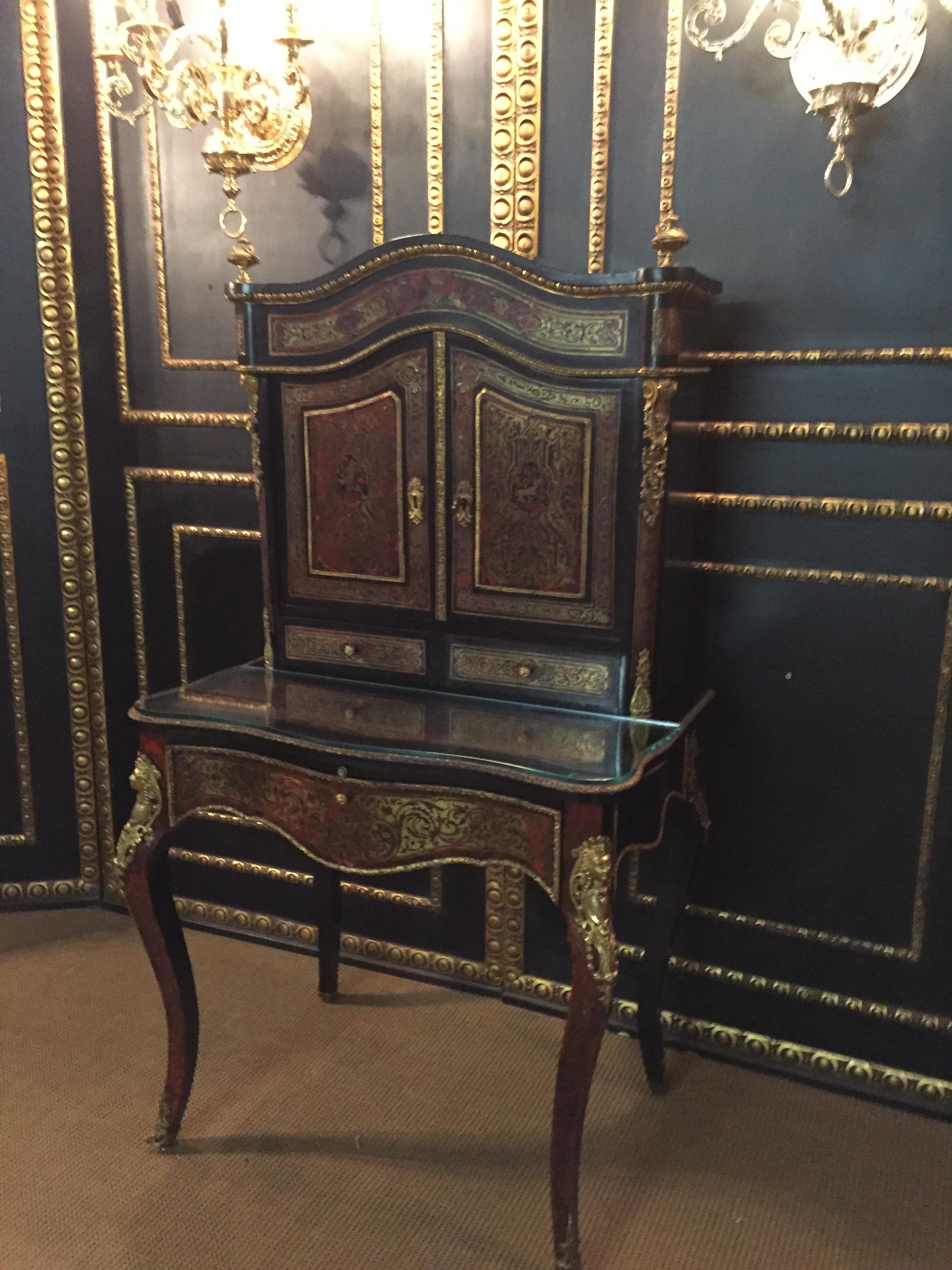 Gilt bronze are distinctive and of exceptionally good quality. Ebonized solid oakwood with brass inlays Boulle technique. The top are two wide doors with an infill filled panel flanked by fittings in the form of female masks on a curved frame. Fries