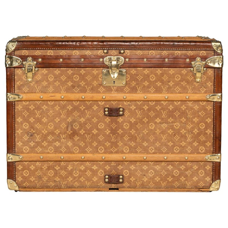 This trunk is one of the first ever made by Louis Vuitton. It is  characterized by the flat top and wooden frame, c…