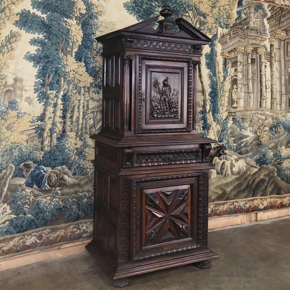 19th century Louis XIII French walnut two-tiered cabinet was designed to accommodate a wealthy gentleman's personal effects, with lockable cabinets above and below, and a convenient drawer into which one could empty one's pockets upon arrival at