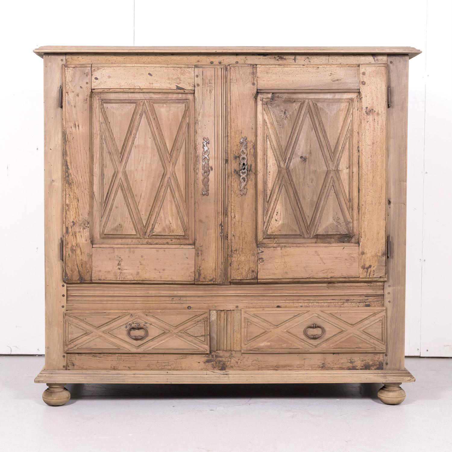 19th century Louis XIII style bleached walnut buffet d'appui handcrafted by talented artisans in the French Basque Country, circa 1870s. This handsome buffet features two doors with raised diamante point decoration that open to reveal a single shelf