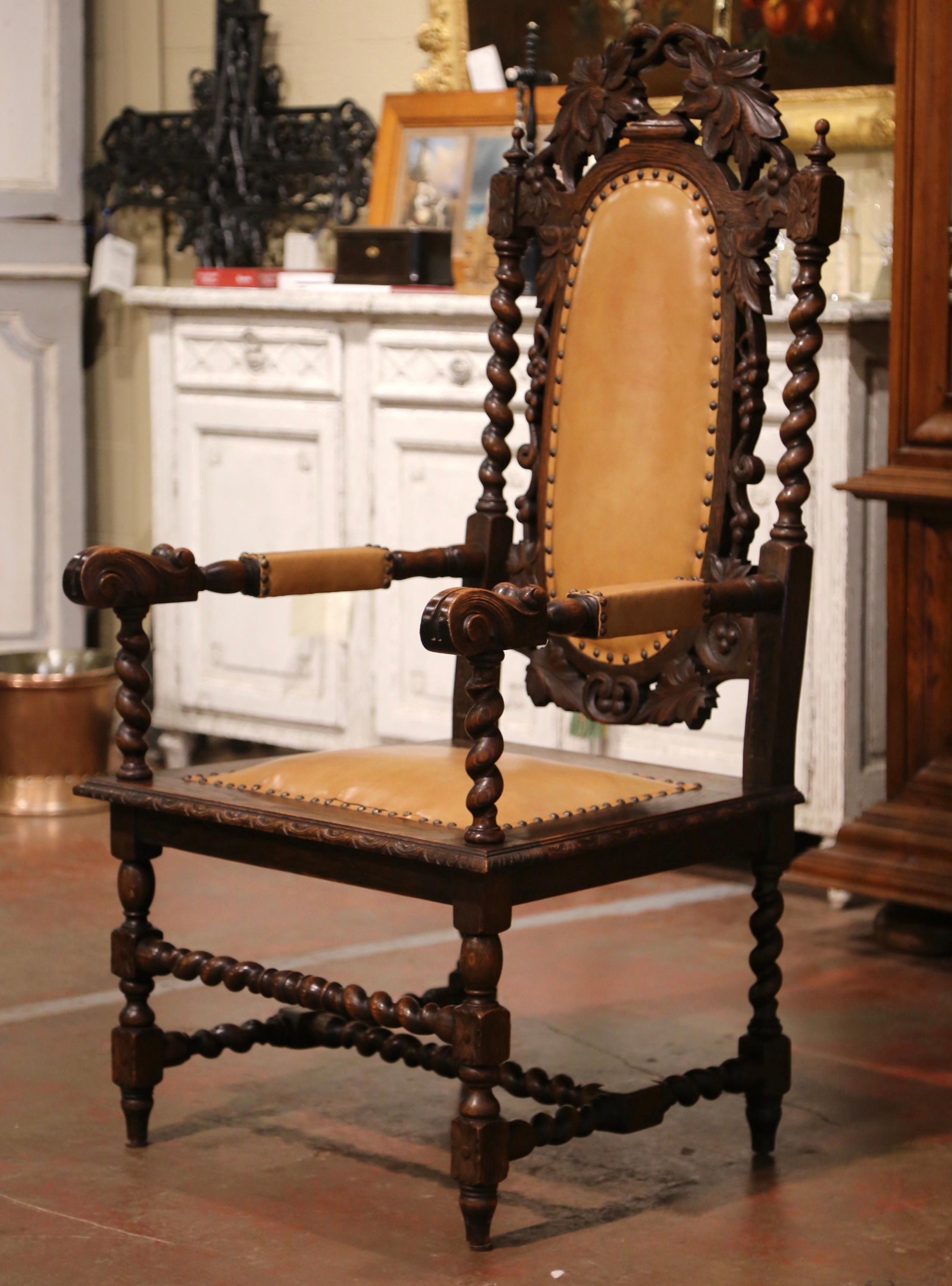 Decorate an office or a study with this large antique king armchair. Hand carved by Karpen Furniture in Chicago, the important chair stands on turned legs ending with tapered feet over a barley twist stretcher. The chair features a tall rectangular