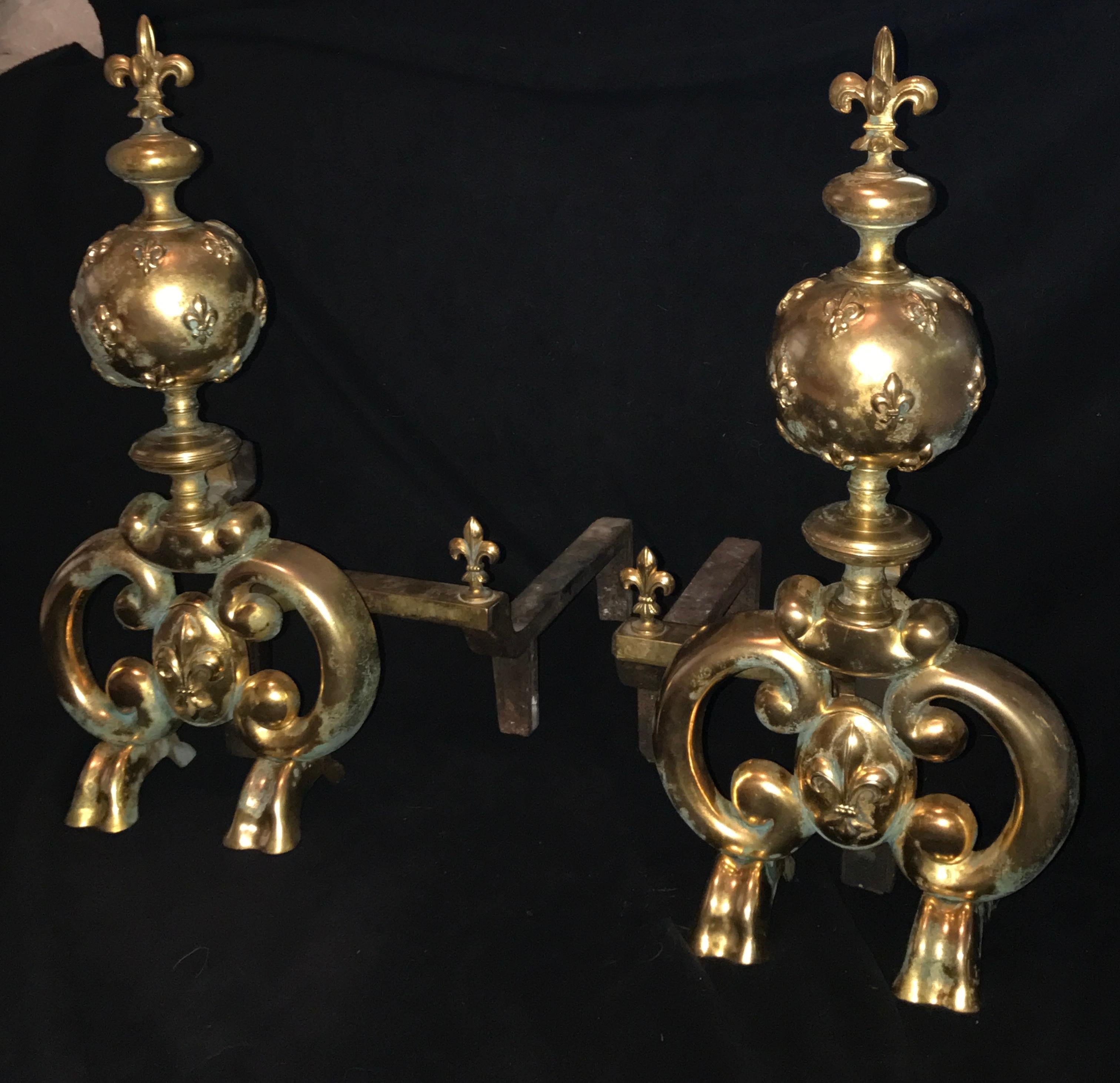 Nice pair of Fleur de Lys decorated, Louis XIV style andirons with extensions. Very functional as well as beautiful, Made in the late 19th century. Gilt bronze and Iron.