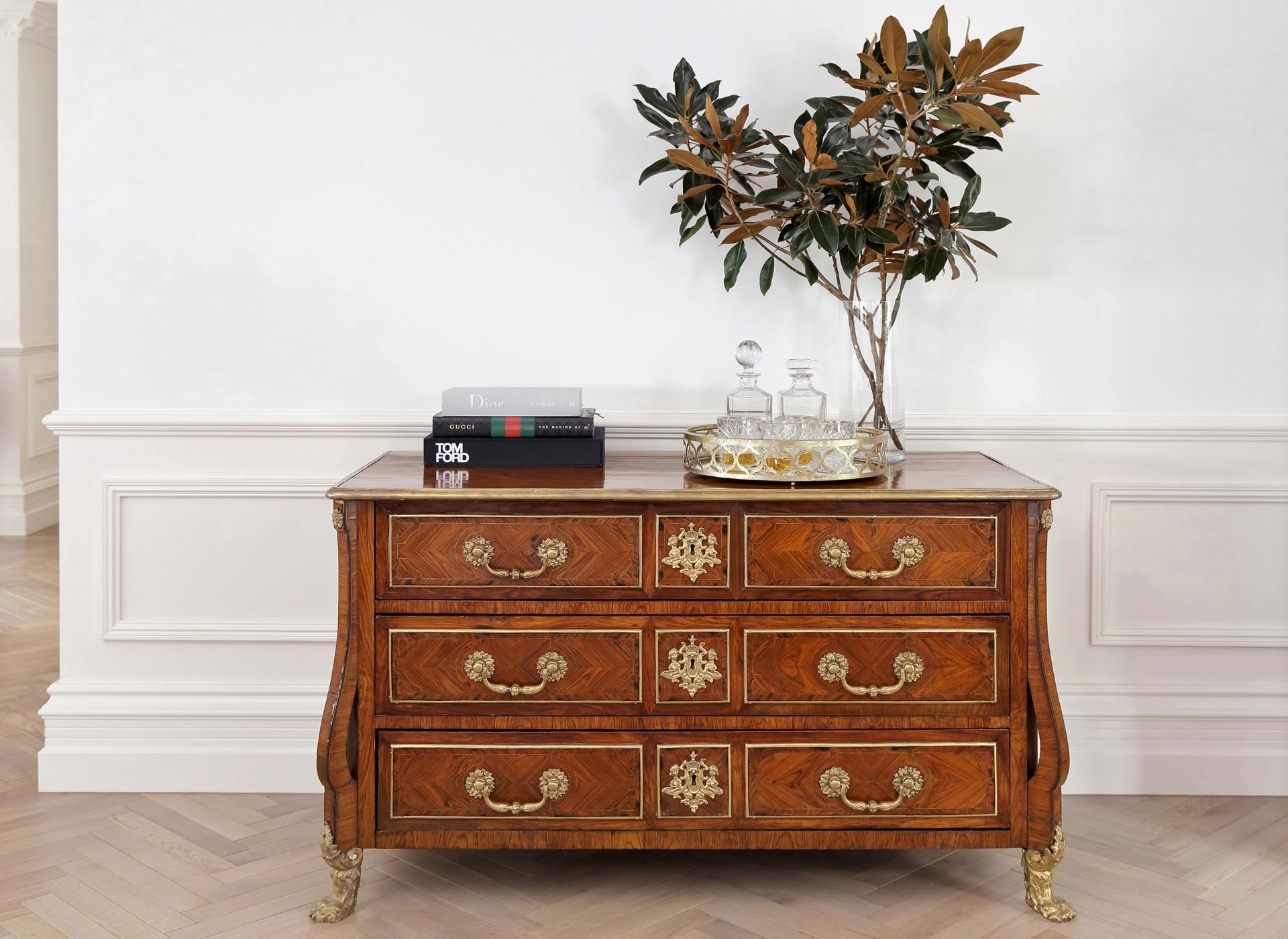 A Late Louis XIV Style Kingwood and Fruitwood Marquetry and Gilt Bronze Commode, presenting exceptional quality, design and craftsmanship.

The front, sides and legs of the commode are entirely veneered with a complicated parquetry pattern in