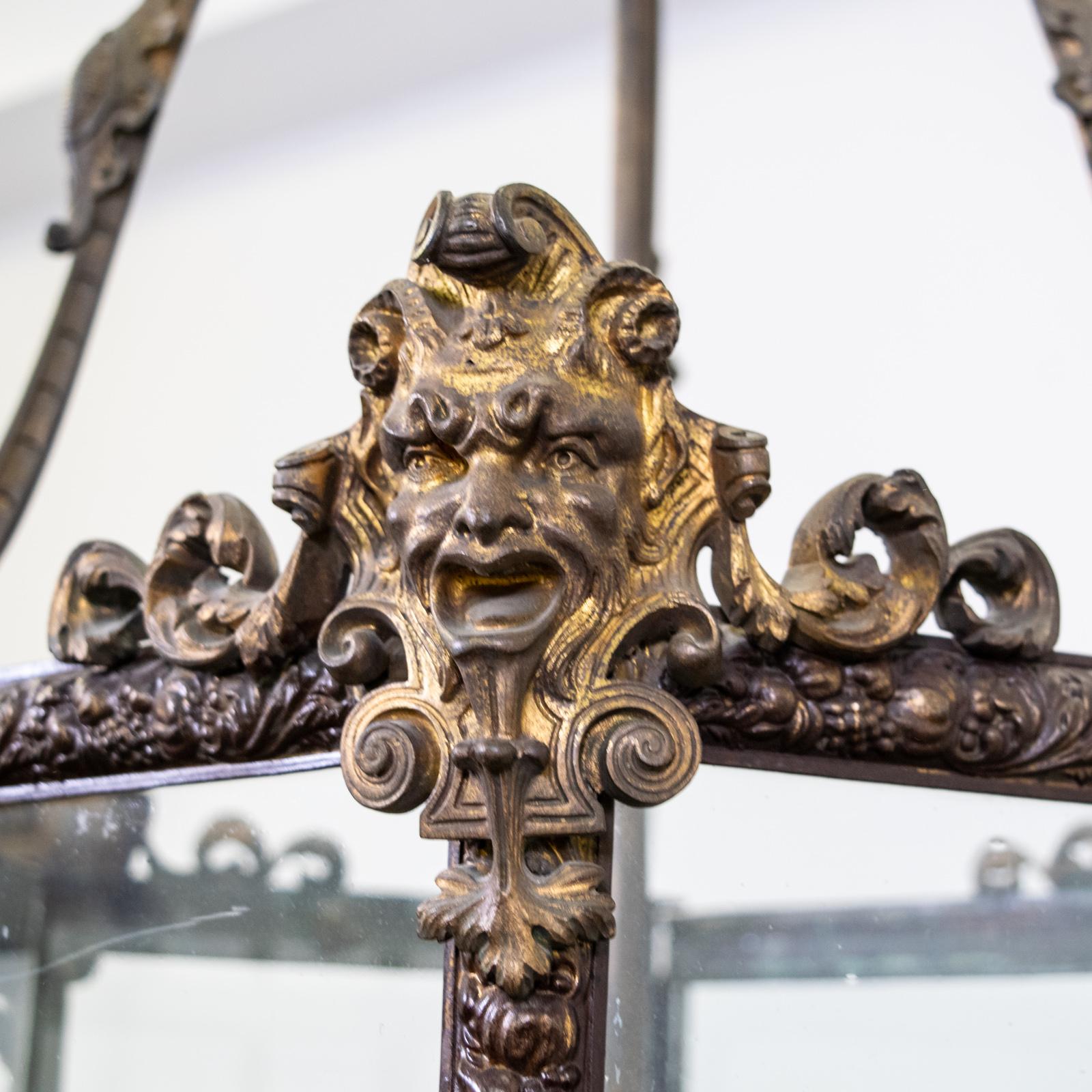 19th century Louis XIV style repousse brass and ormolu hexagonal lantern

The three hanging arms terminating with ormolu masks. With three lights to the interior.

The floral pressed metal with remnants of gilt throughout

 