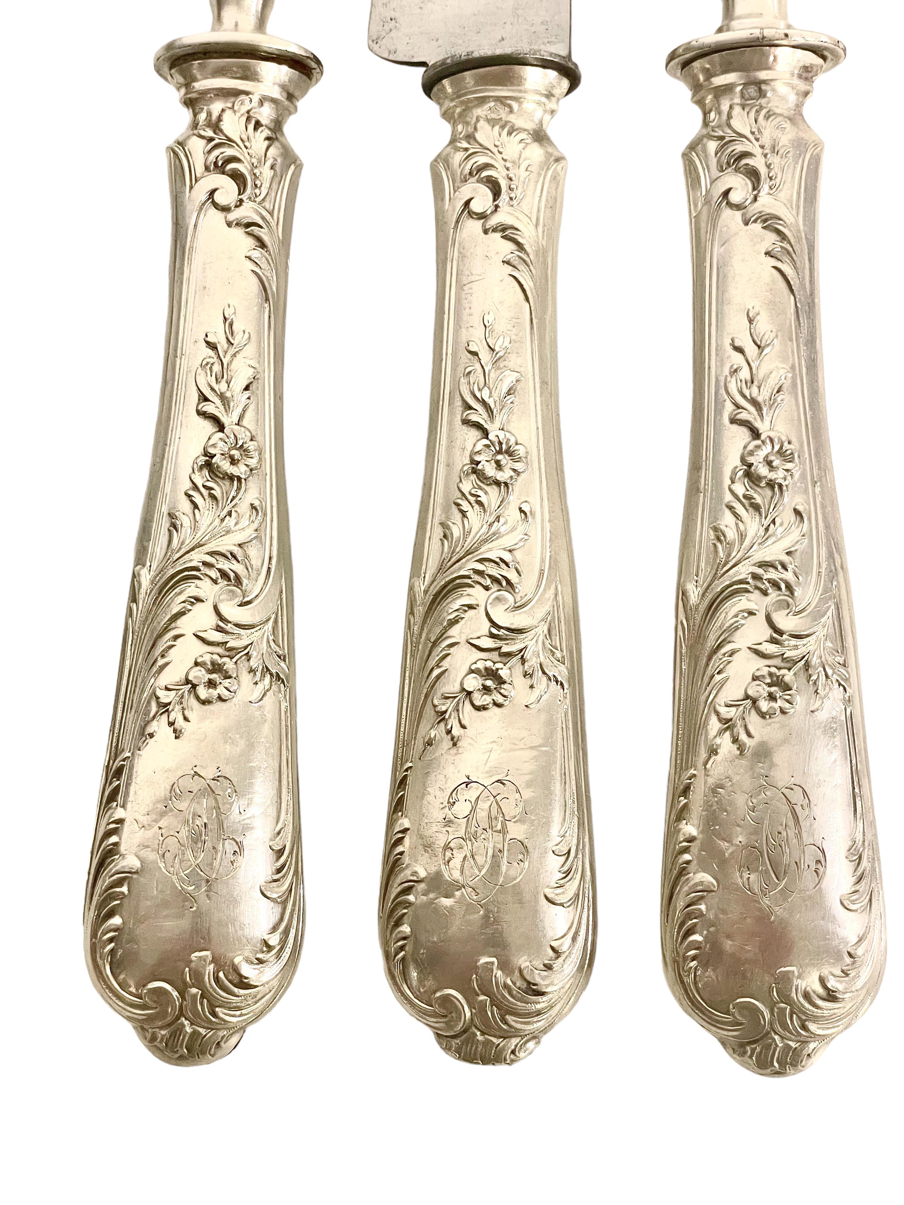 A superbly presented Louis XIV style three piece 'Gigot' lamb carving set, comprising a carving knife, carving fork and leg-bone holder, or 'manche à gigot'. The leg-bone holder is an unusual item, and is used to assist in the carving of a joint of