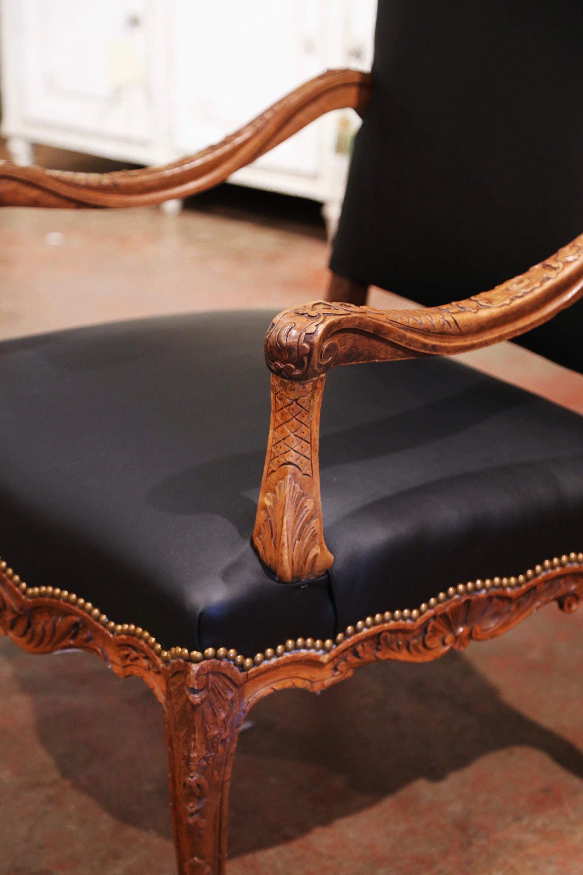 Decorate a study or office with this elegant antique armchair. Crafted in southern France circa 1880, the comfortable fauteuil sits on four cabriole legs decorated with acanthus leaves at the shoulder and ending with escargot feet. The armchair has