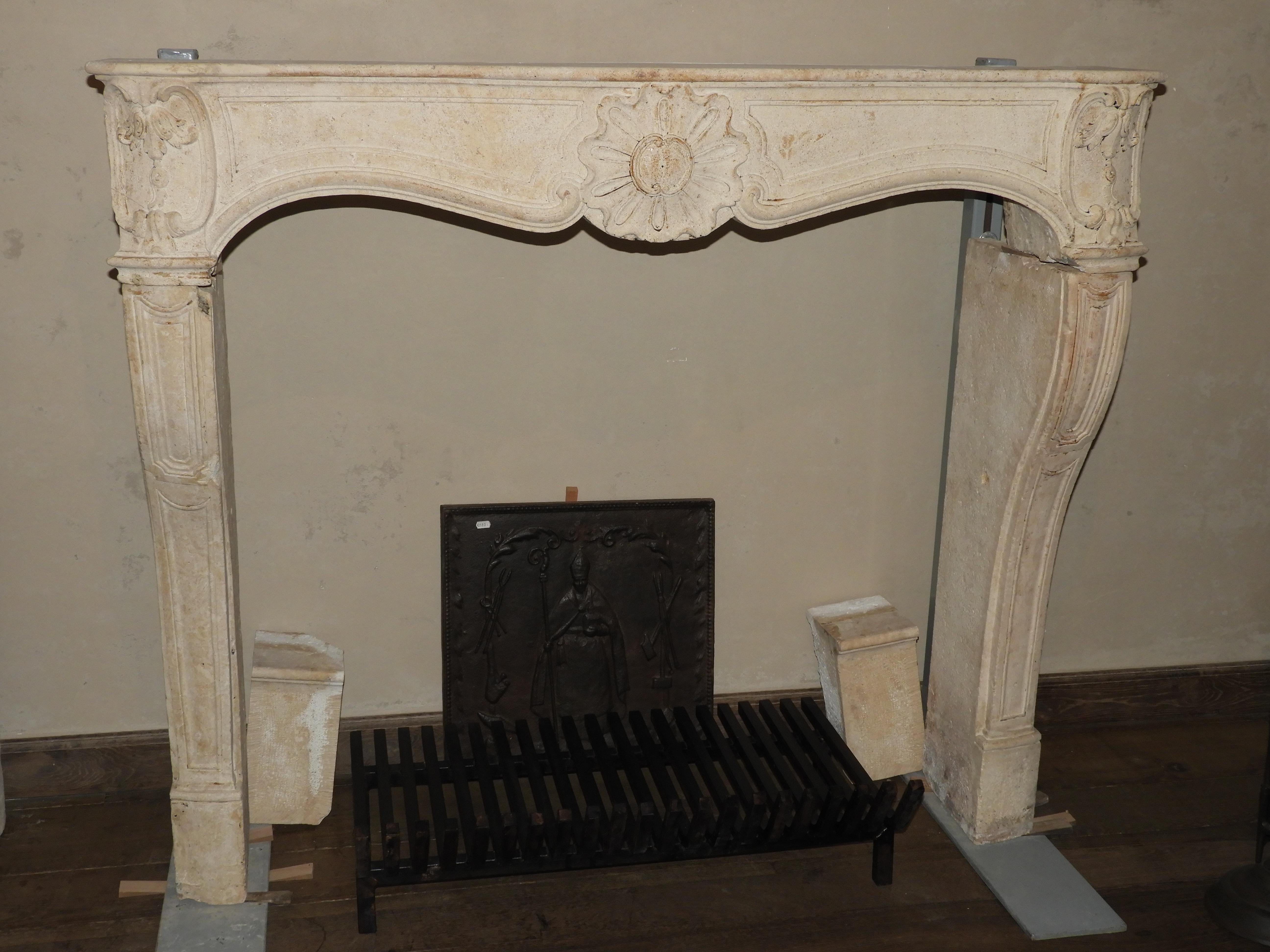 Early 19th century Louis XV style fireplace in white/cream colored limestone , wit an interior size of 113 cm wide x 98 cm high .