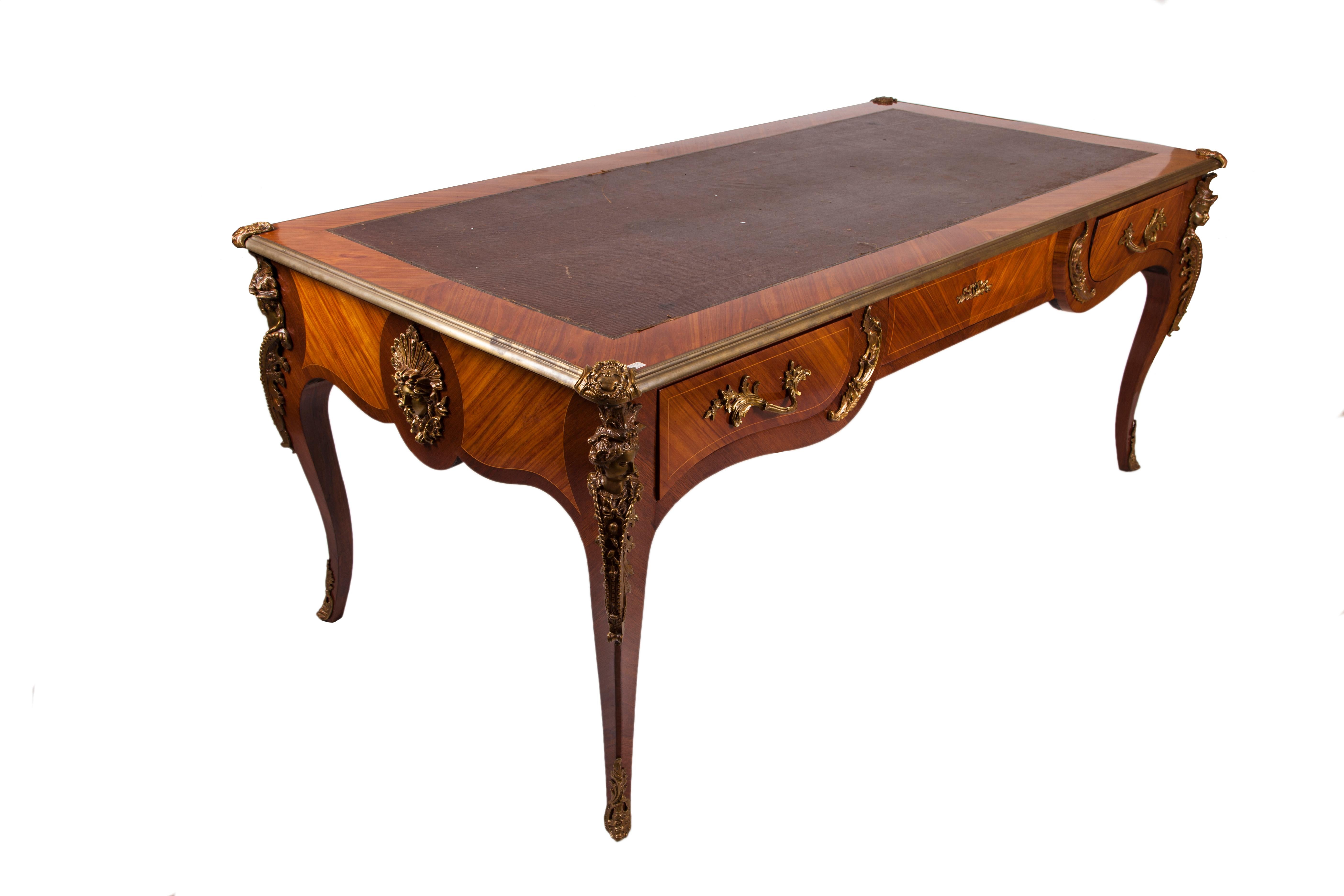Large and important 19th century French desk in kingwood and rosewood, Louis XV style. It can be used on both sides and it has three drawers on each front. Top in brown leather with some signs of wear. Beautiful frames in gilded bronze. Busts of