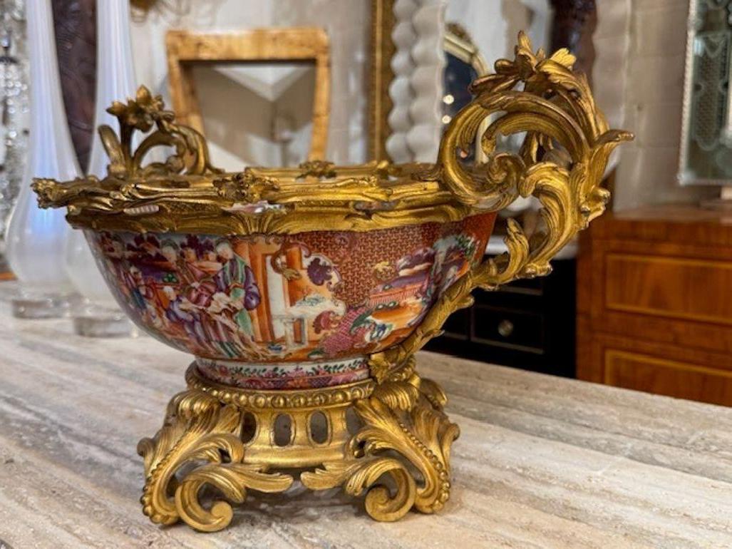 The 19th Century Louis XV Gilt Bronze and Rose Medallion Centerpiece is a stunning piece of home decor that exudes elegance and sophistication. The intricate design features beautiful a beautiful rose medallion pattern, adding a touch of luxury to