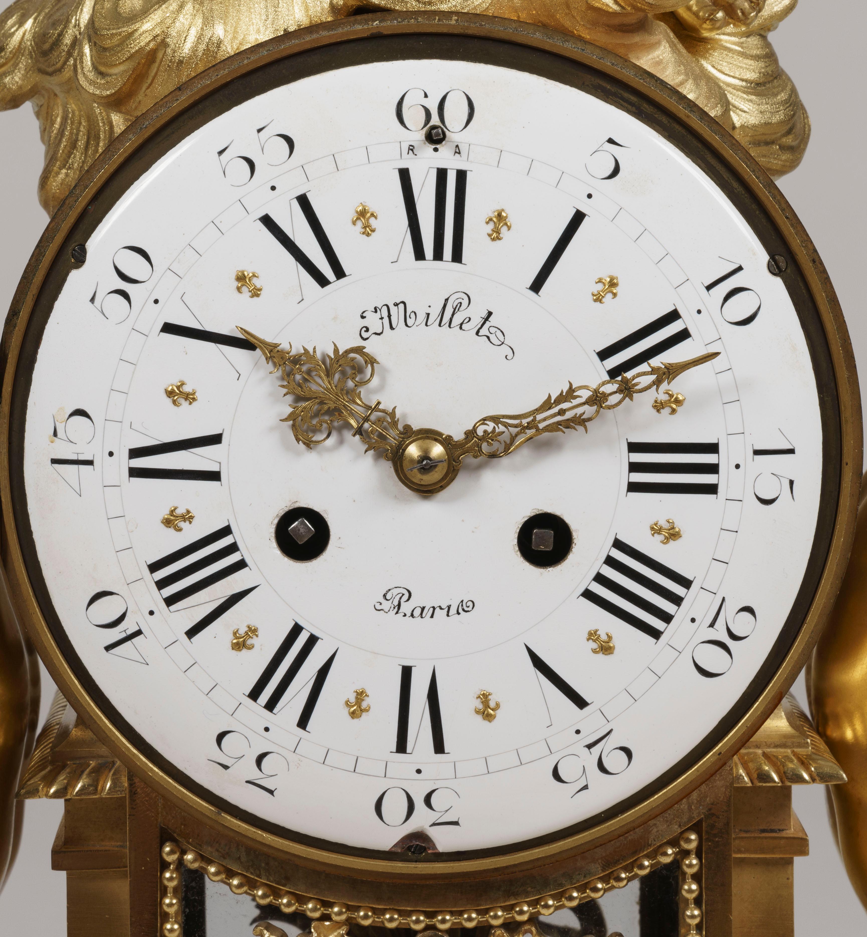 A mantle clock in the Louis XV manner by Millet of Paris

Constructed in white Carrara marble and gilt bronze; the rectangular form base having bowed ends, rises from gilt toupie feet, and has opposed gilt sphinxes and gilt bronze foliate mounts
