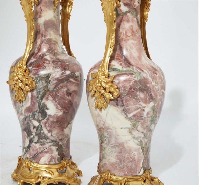 A pair of Louis XV style gilt bronze mounted breche violette marble vases, late 19th century.