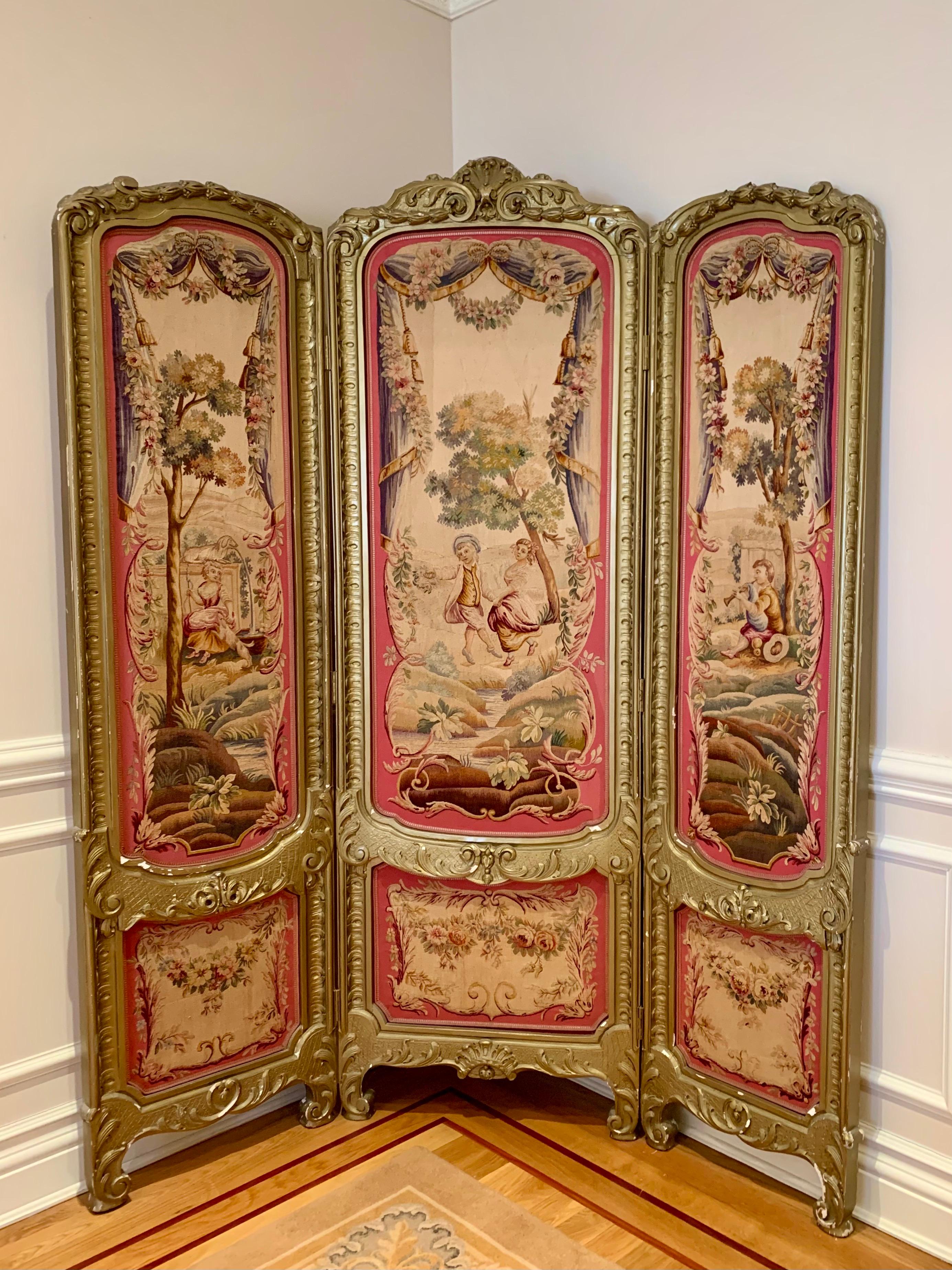 Gorgeous 19th century Louis XV Regency gilded screen and fire screen with Tapestries. The Rococo style tapestries are in pristine condition with very minor loss of gilding to the frames. The larger three panel screen has a pristine pink satin